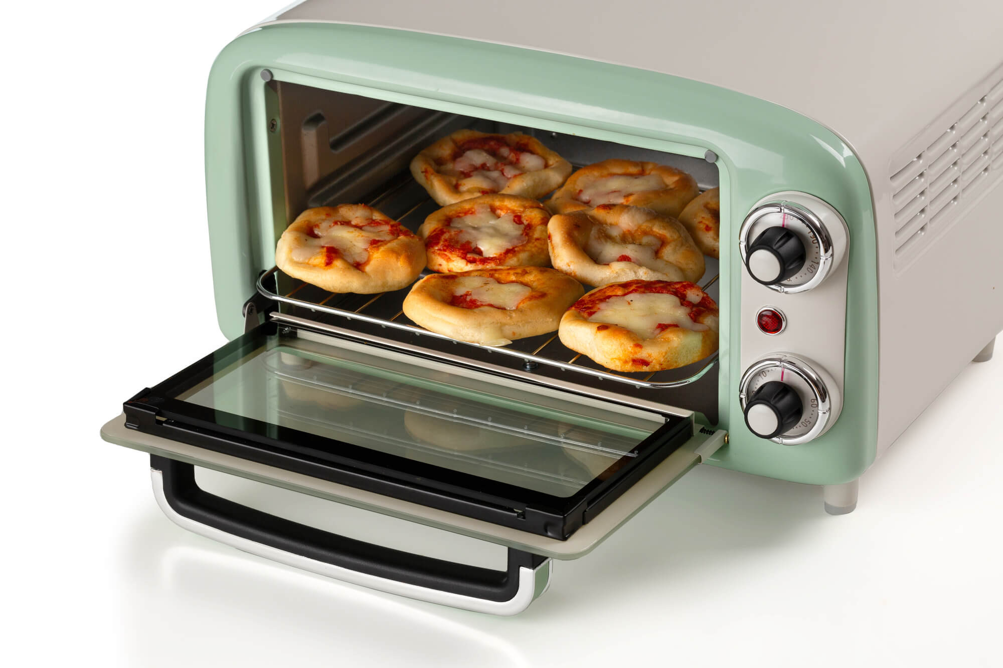 Mini piekarnik w stylu retro z pizzą w środku. Piekarnik jest biały i miętowo-zielony.