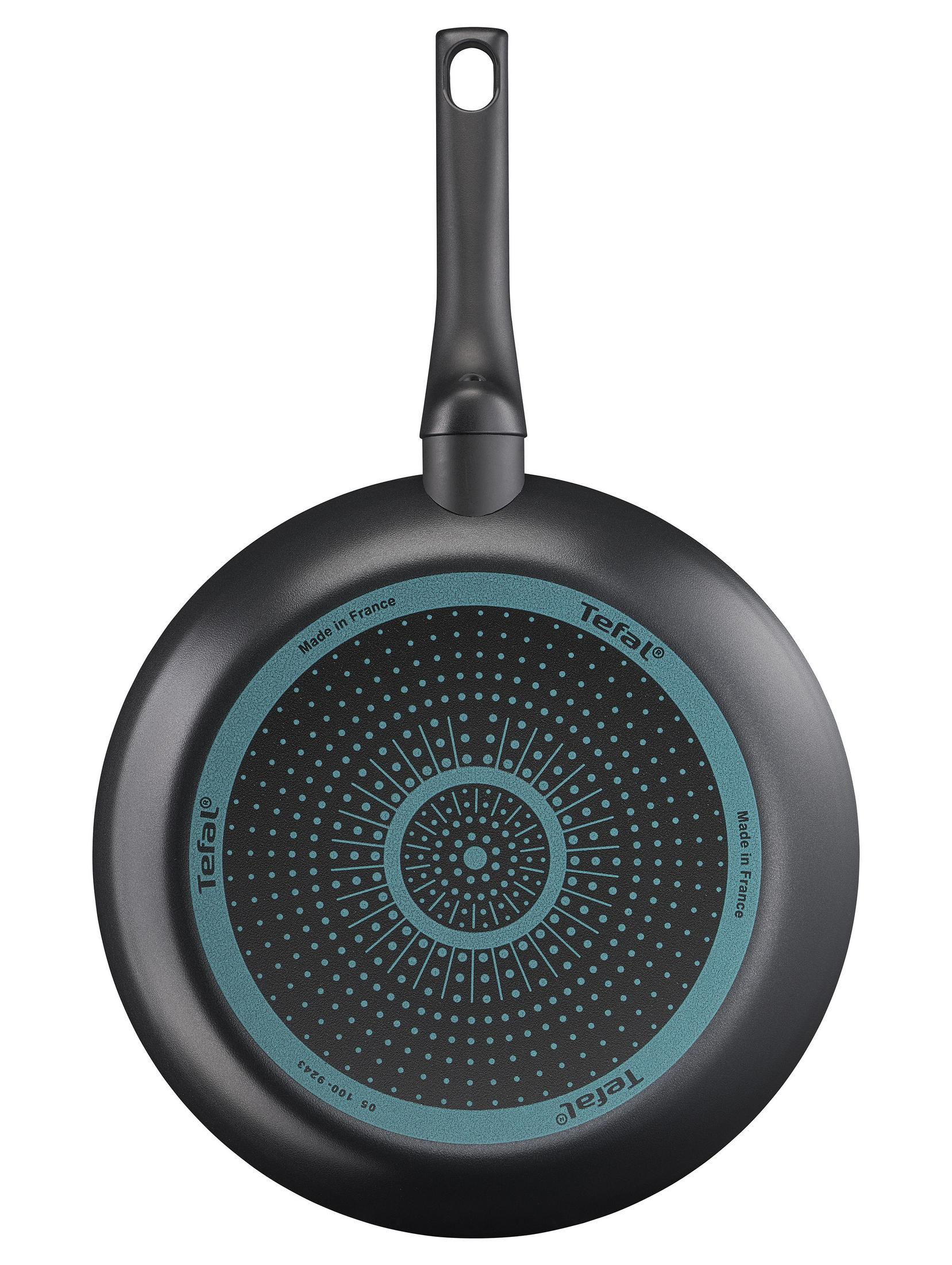 Czarna patelnia Tefal, widok od spodu. Turkusowy wzór, czarny uchwyt, napis "Made in France".