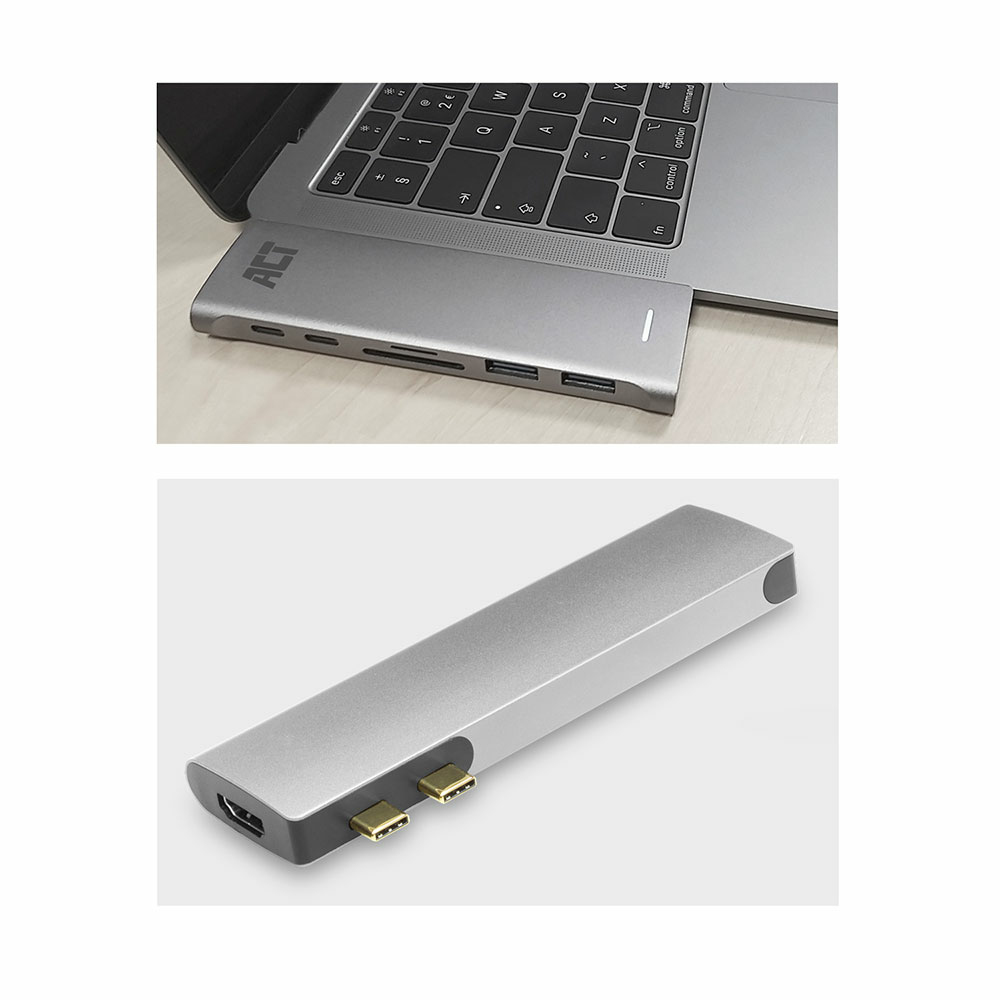 Hub argento collegato a un laptop. Porte HDMI, USB e slot per schede SD visibili.