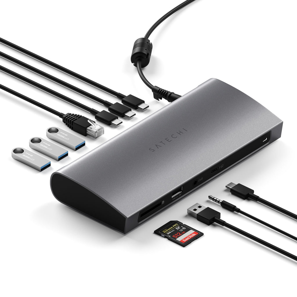 Silberner Satechi-Hub mit verschiedenen Anschlüssen, USB-Laufwerken, einer Speicherkarte und angeschlossenen Kabeln.
