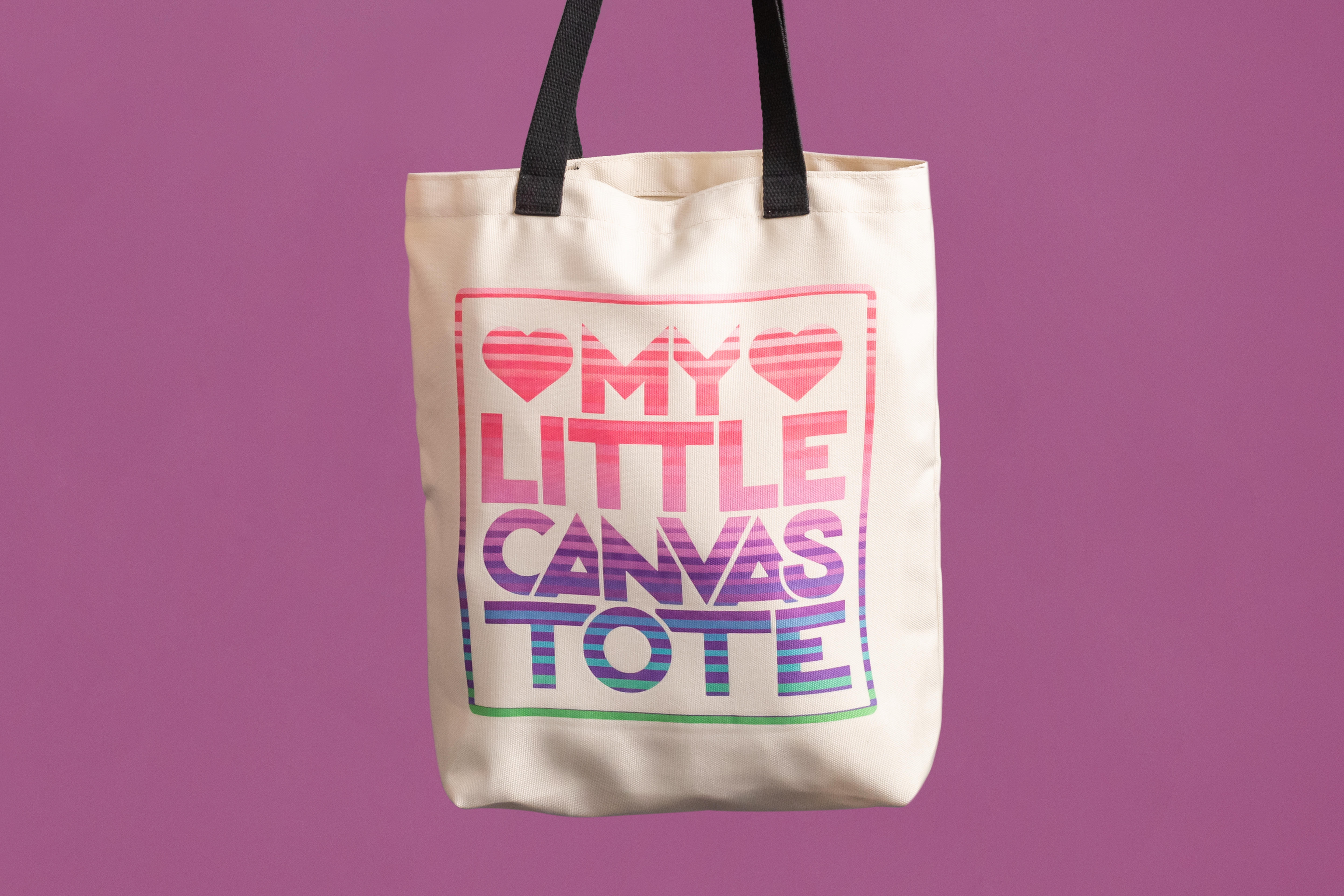 Eine Tragetasche aus Segeltuch mit den Worten "My Little Canvas Tote" in bunten Buchstaben auf lila Hintergrund.
