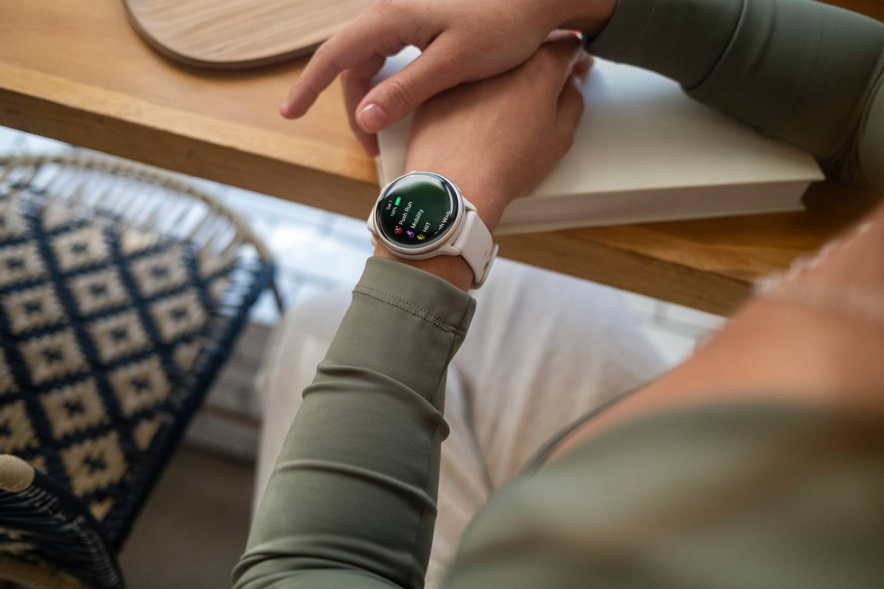 Eine weiße Smartwatch mit weißem Armband, die verschiedene Daten auf dem Bildschirm anzeigt.