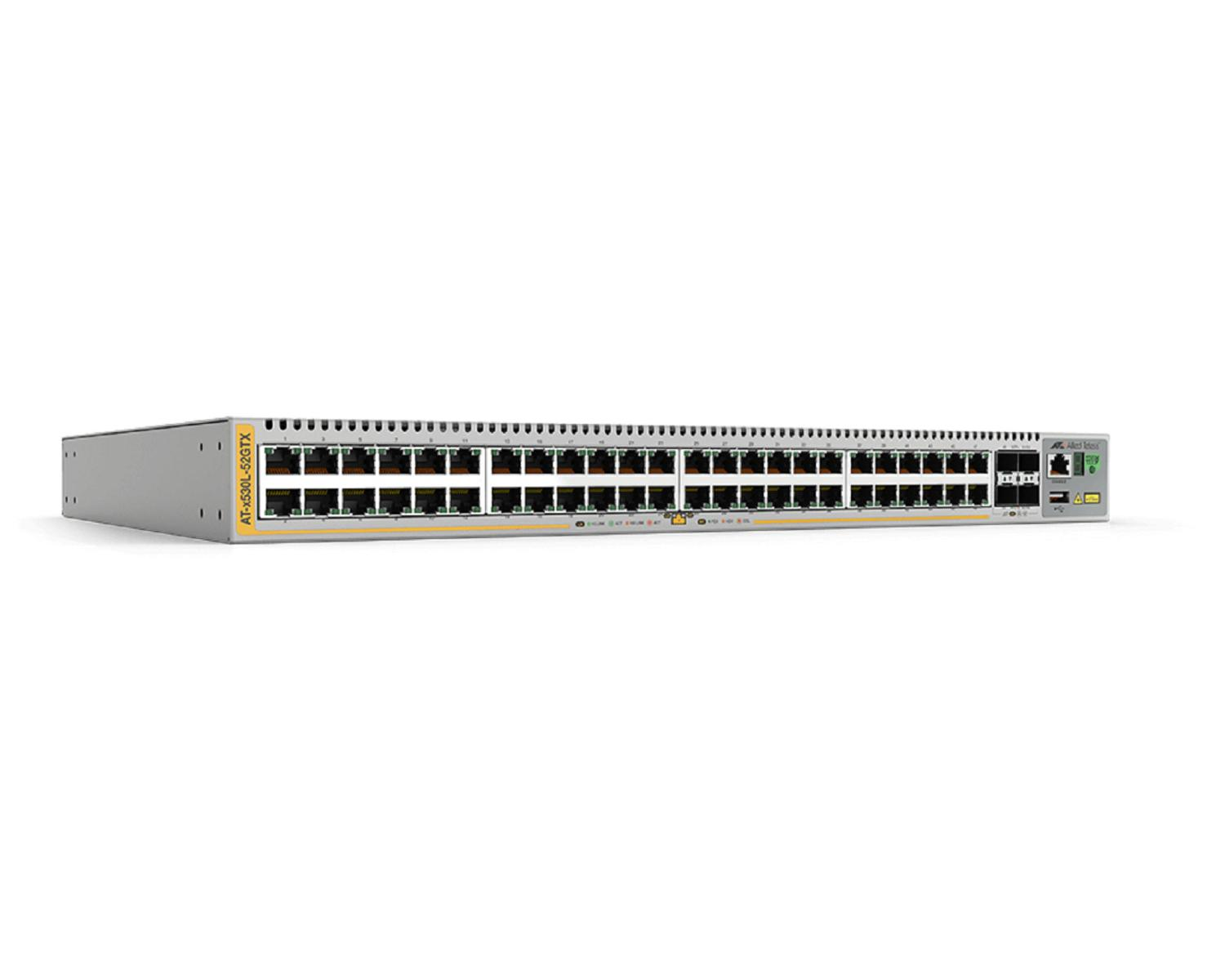 Szary przełącznik sieciowy, żółty akcent, wiele portów, białe tło.