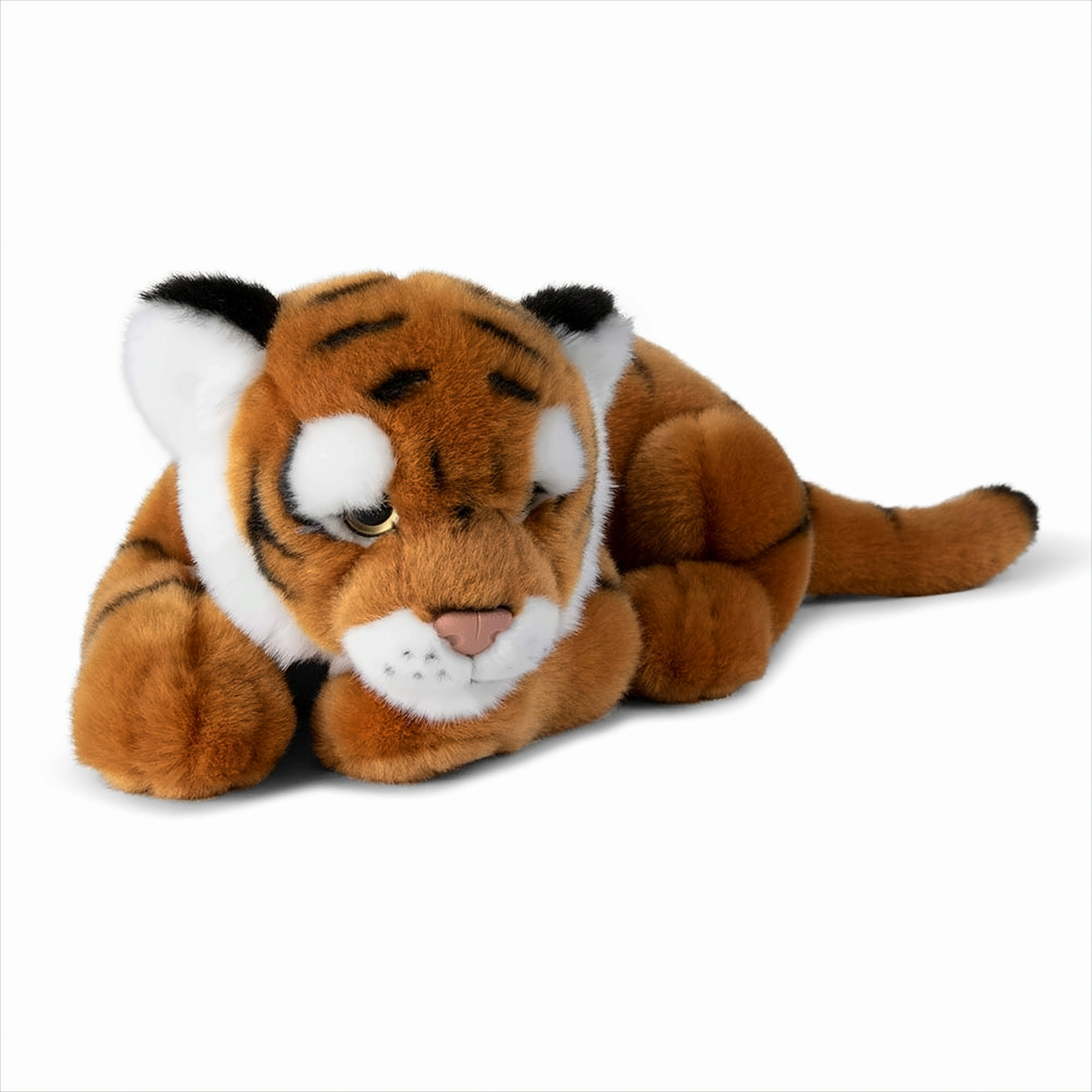 Ein Tiger-Plüschtier liegt auf einer weißen Oberfläche.