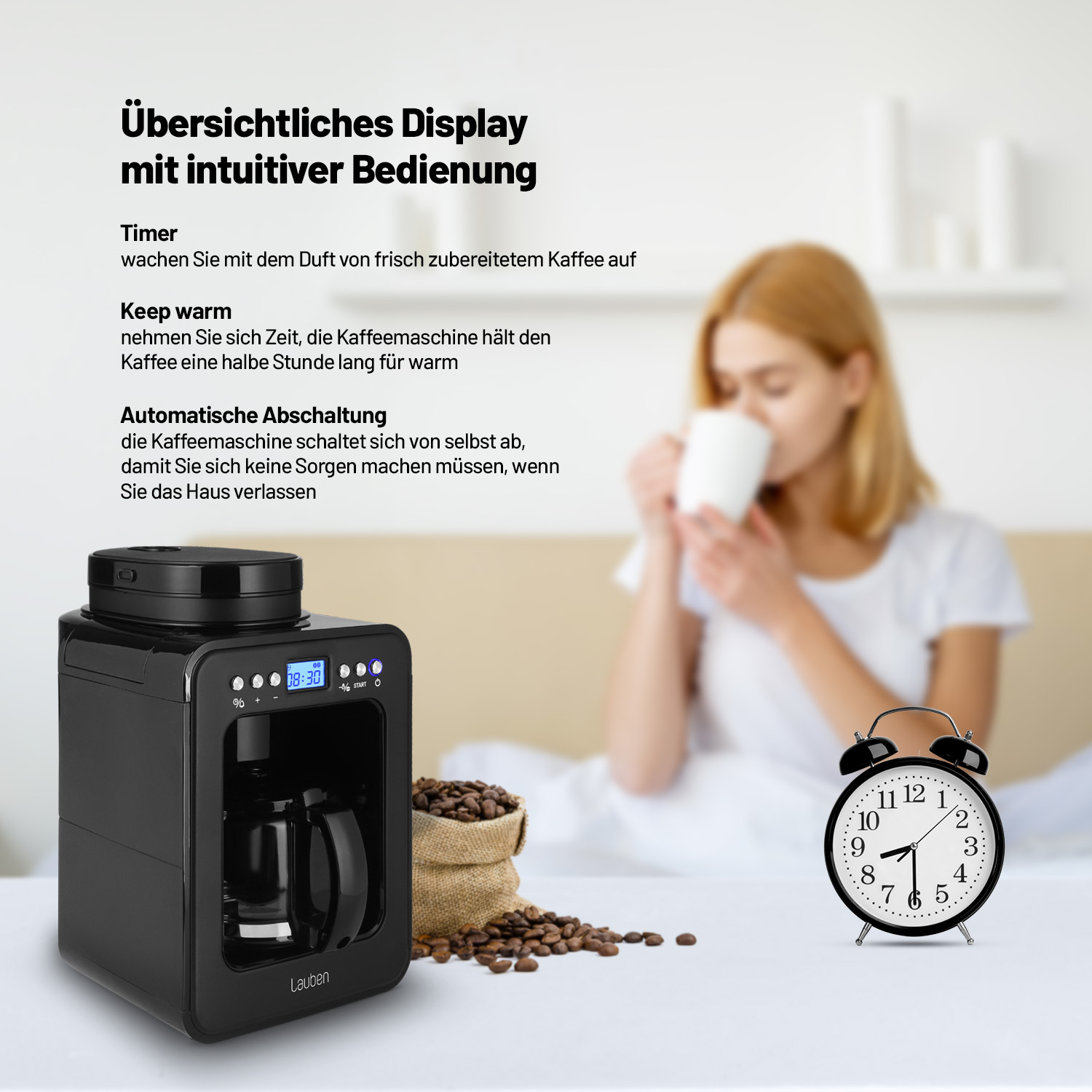 Czarny ekspres do kawy obok budzika i worka z ziarnami kawy. Wyświetlany jest tekst o maszynie.