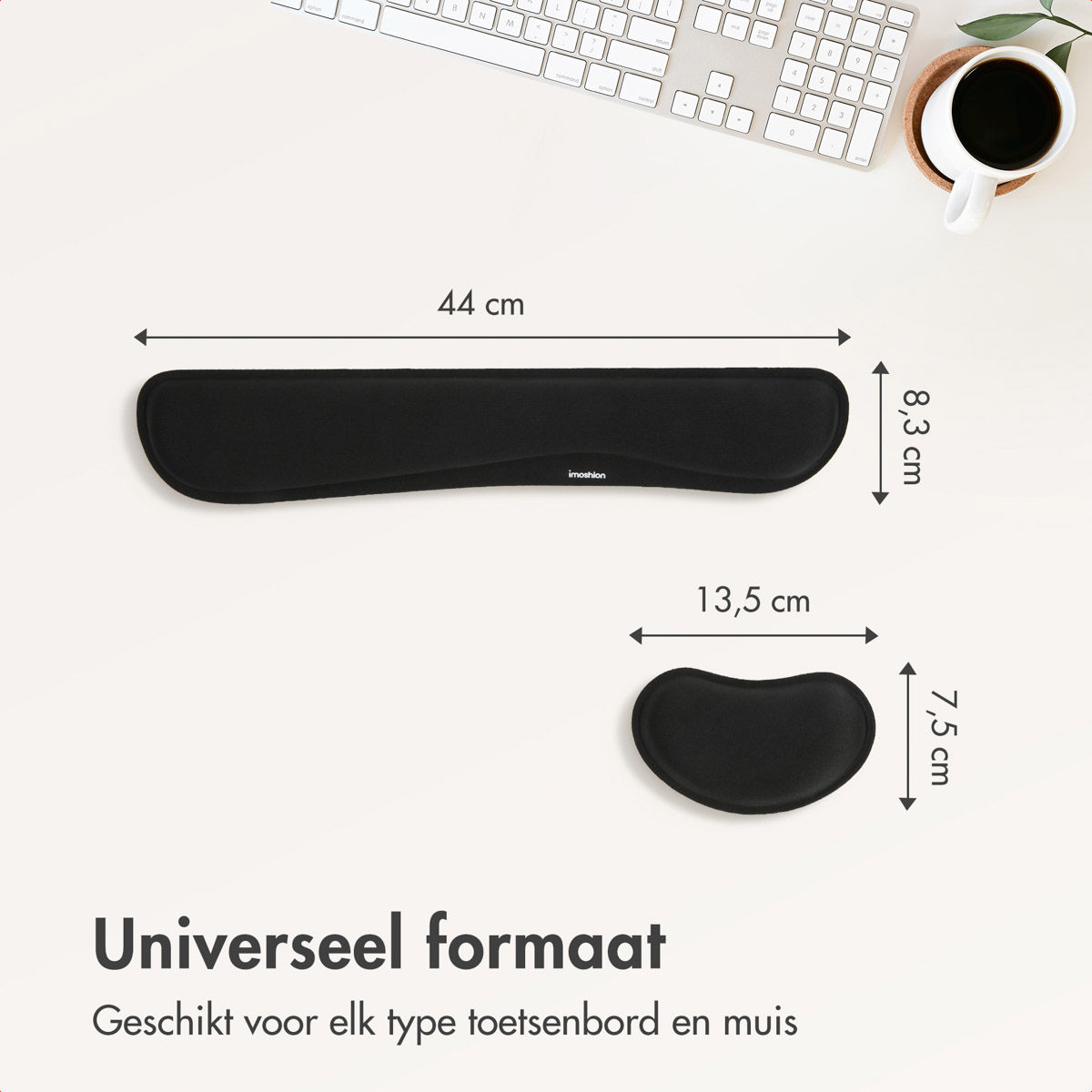 Black wrist rest and mouse pad on white surface with keyboard and cup.