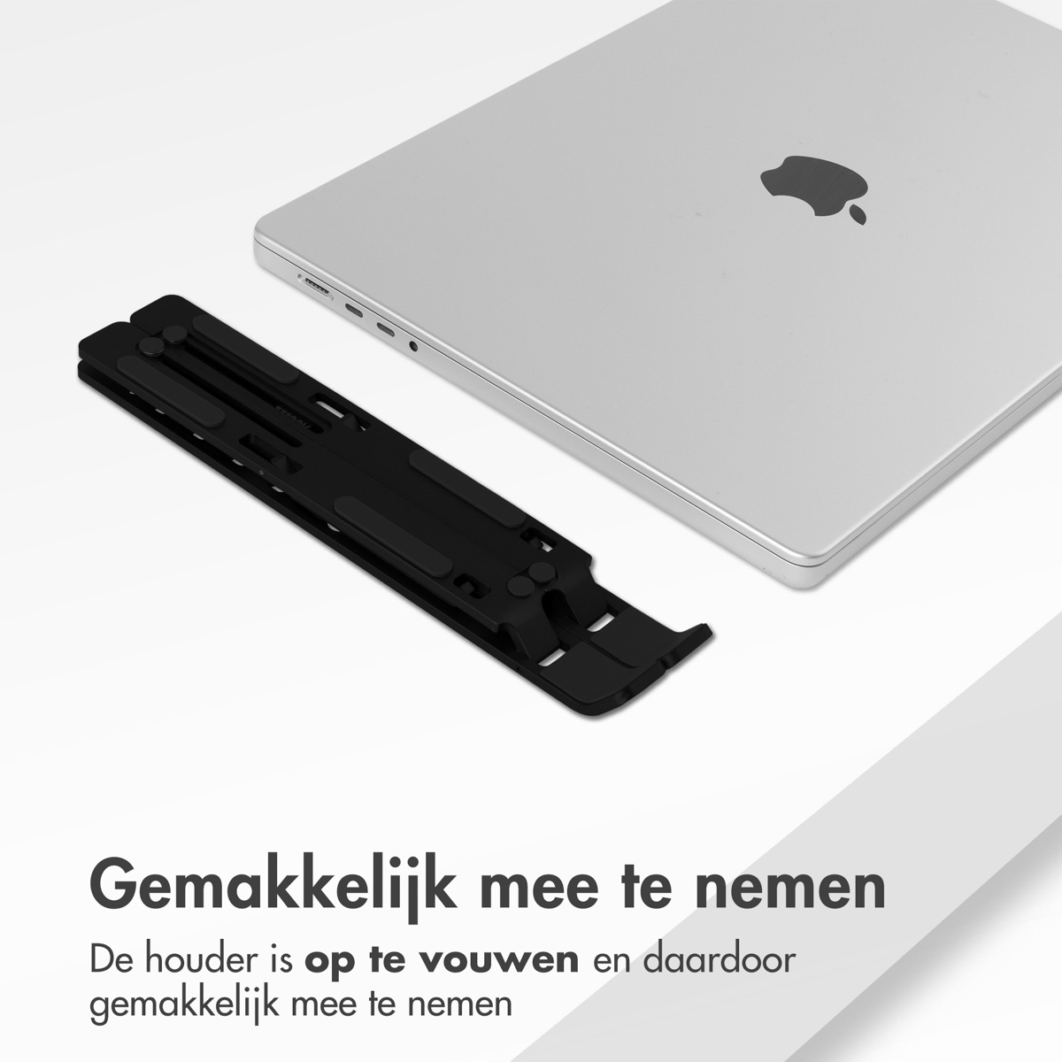 A silver laptop with a black stand. The stand is folded and on a white surface.