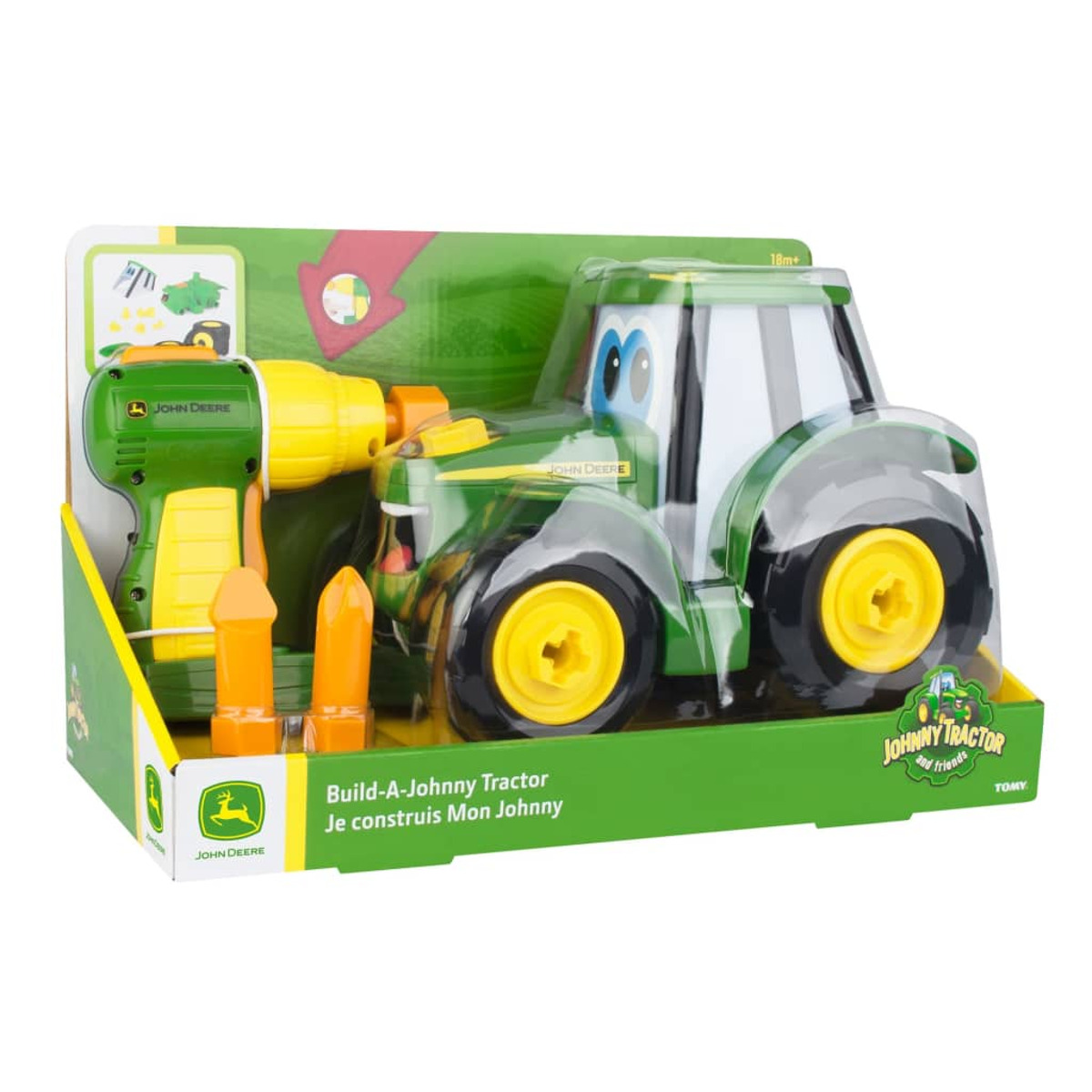 Spielzeugtraktor in Verpackung mit Bohrmaschine und Zubehör, grün und gelb.