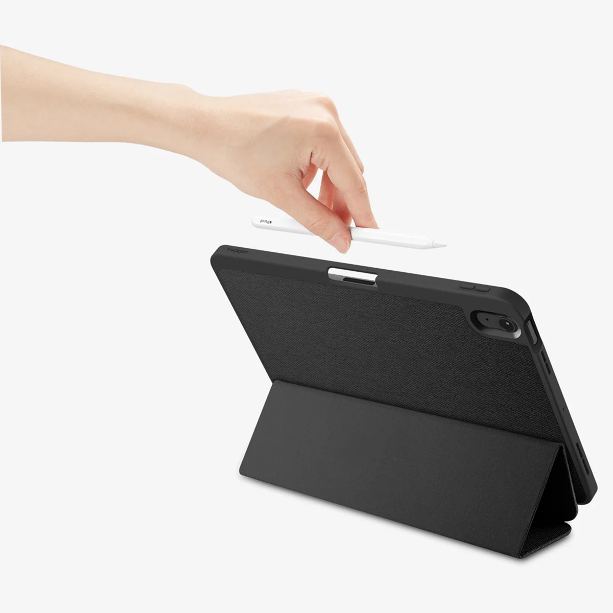 Hand holding a white stylus over a black tablet cover. The cover is open and the tablet is angled. White background.