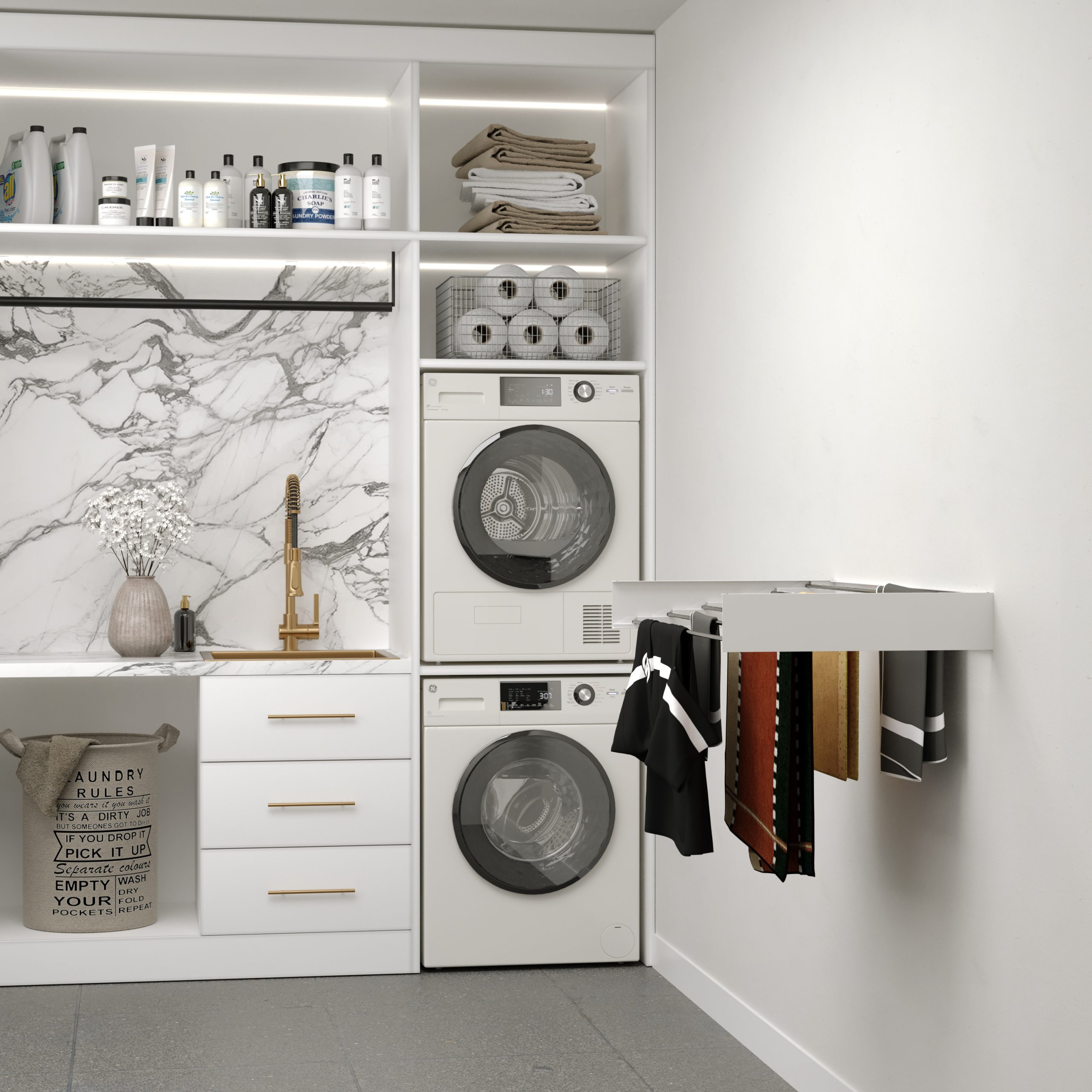 Une buanderie avec une machine à laver, un sèche-linge et des vêtements suspendus.