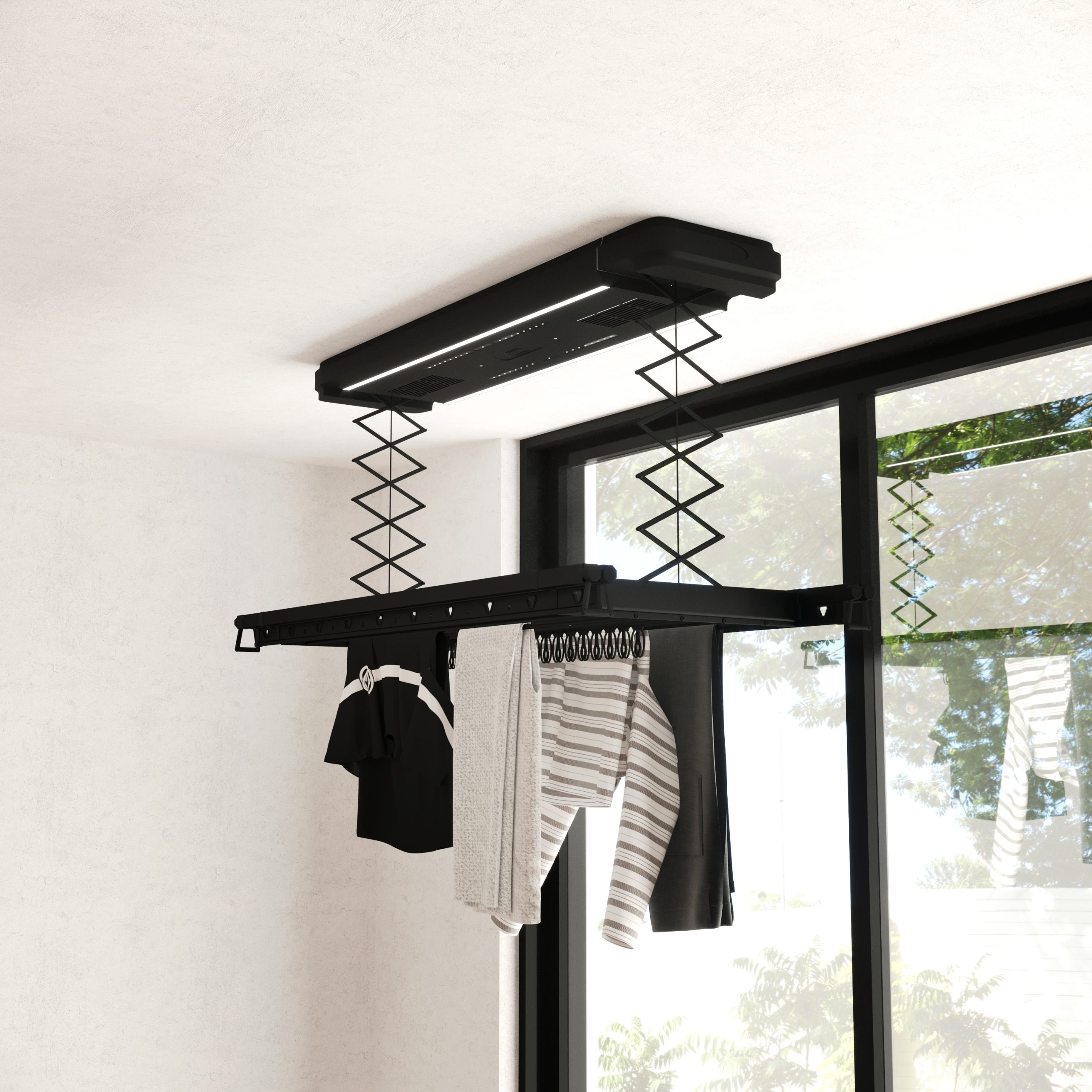 Een zwart aan het plafond gemonteerd droogrek met hangende kleding.