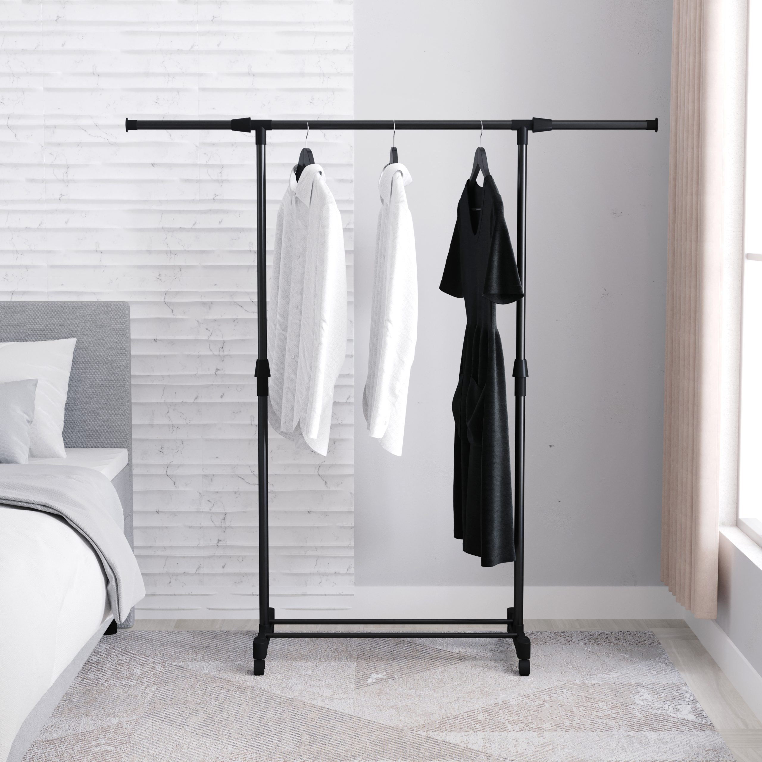 A black clothes rack with white and black shirts hanging on it, in a bedroom setting. A window in the background.