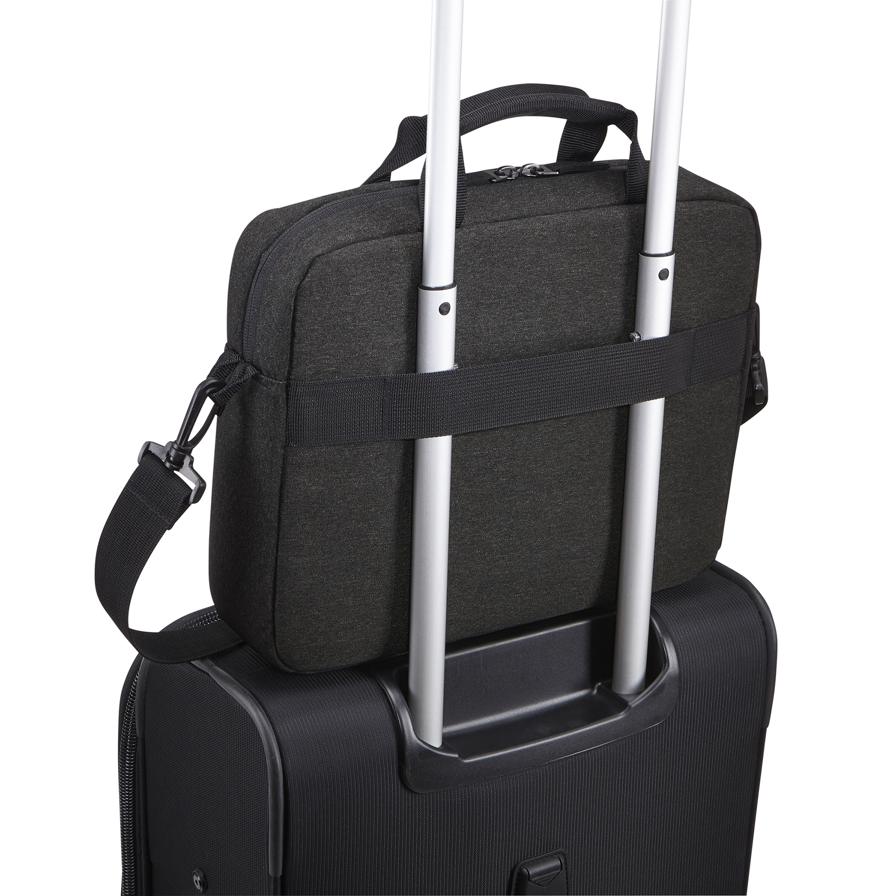 Serviette en tissu noir sur une valise noire avec poignée. Poignées argentées.
