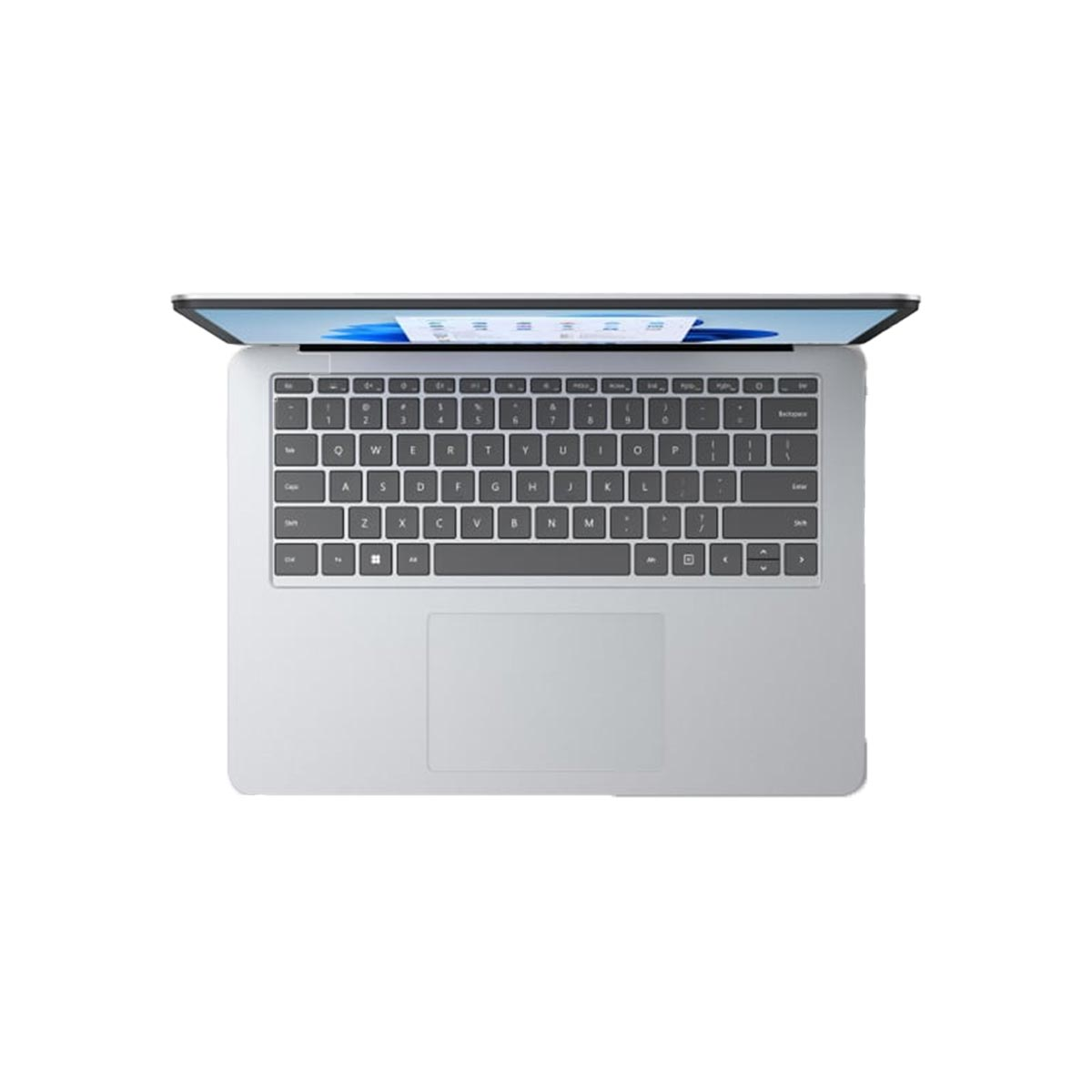 Srebrny laptop, otwarty, widok z góry. Klawiatura widoczna. Białe tło.