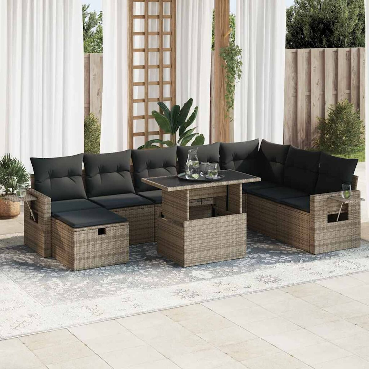 Rattan-Sofa-Set für den Außenbereich mit Tisch und dunklen Kissen.