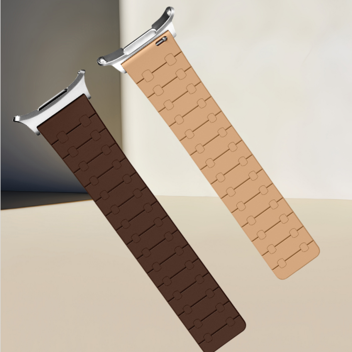 Due cinturini per orologi, marrone e beige. Entrambi sono in gomma, con attacchi metallici argentati.