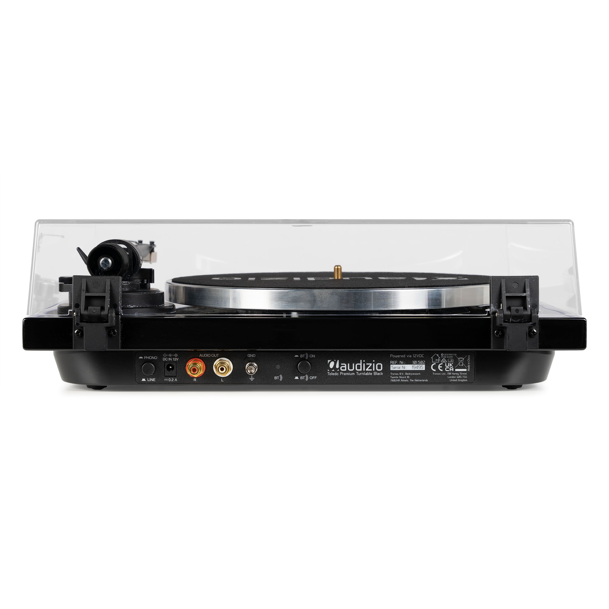 Tocadiscos con tapa transparente, mostrando controles y conexiones en la parte trasera.