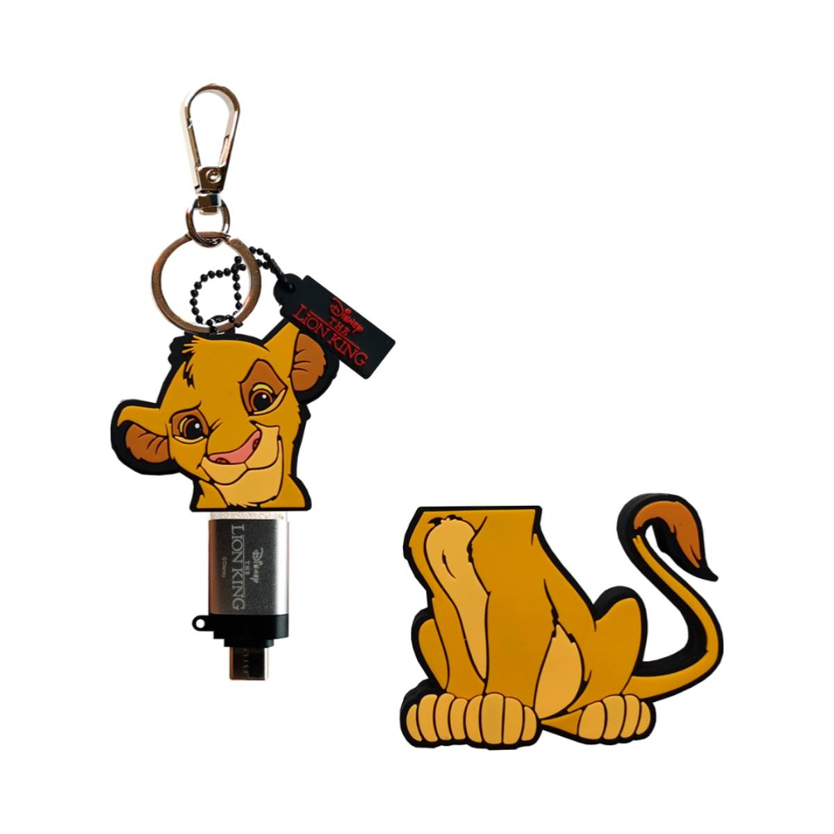 Ein USB-Stick im Lion King-Design und eine Löwenfigur. Der Löwe ist gelb mit schwarzem Anhänger.