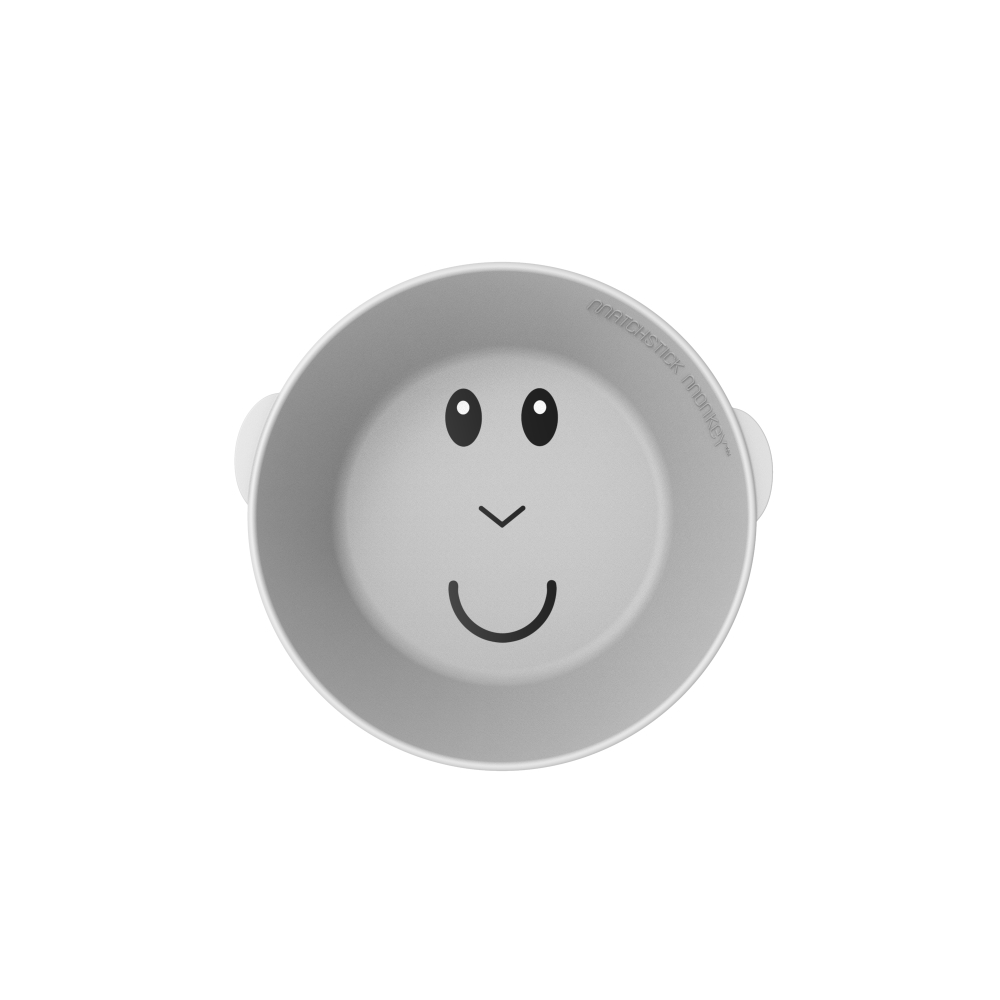 Eine graue, runde Schüssel mit einem lächelnden Gesicht darauf. Die Schüssel hat kleine Ohren.
