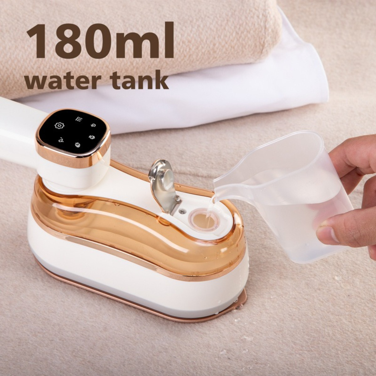 Weißer und goldener Steamer, der mit Wasser gefüllt wird. Eine Hand gießt Wasser aus einem Messbecher.
