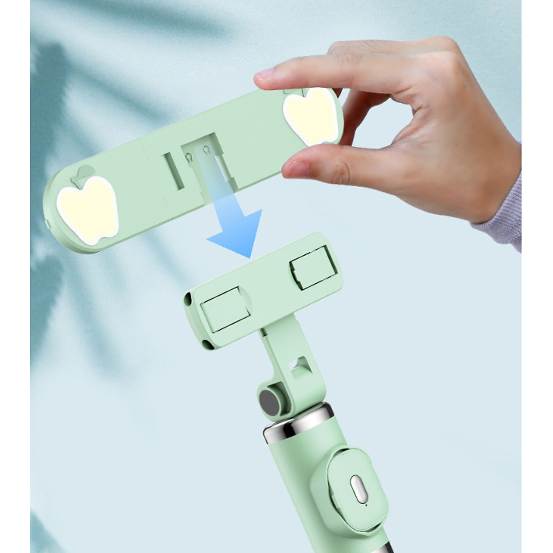 Ein hellgrüner Selfie-Stick wird gezeigt. Er hat eine Handyhalterung und ein abnehmbares Teil.