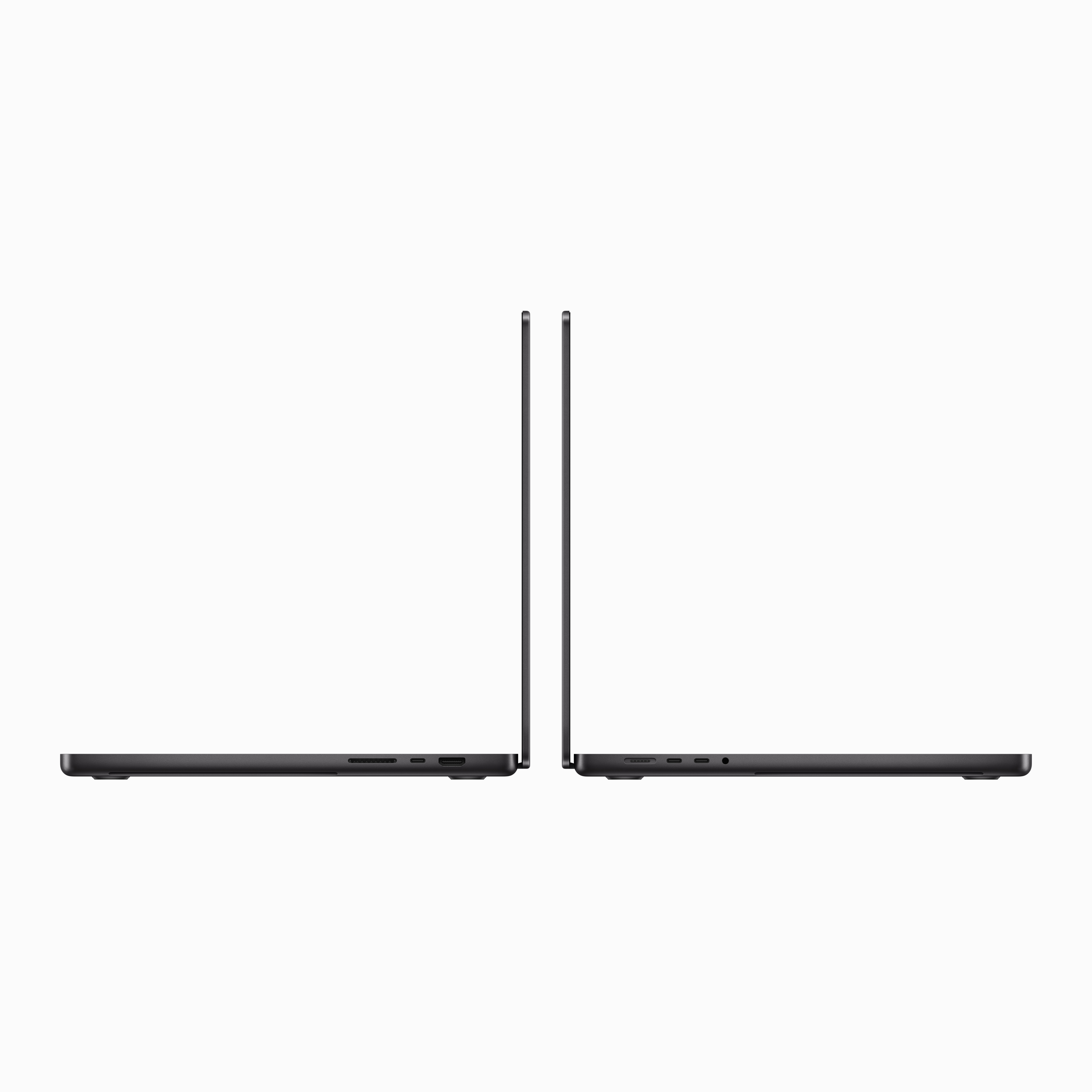 Dwa czarne laptopy obok siebie, zamknięte. Widok z profilu, białe tło.