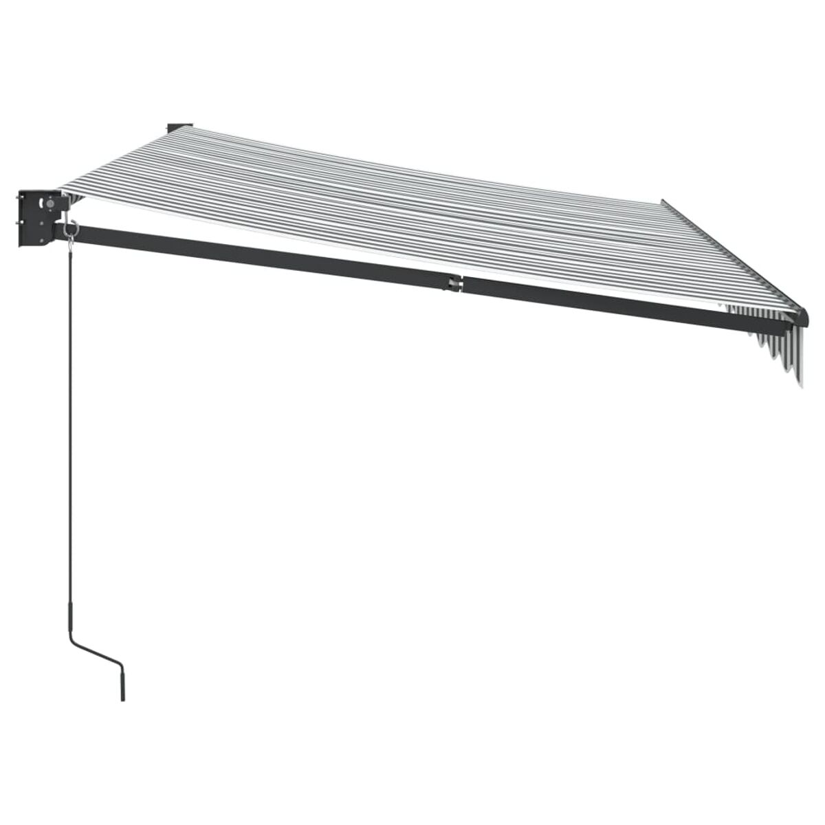 Tenda da sole retrattile estesa. Ha un tessuto a righe bianche e grigie. Telaio e braccio neri.