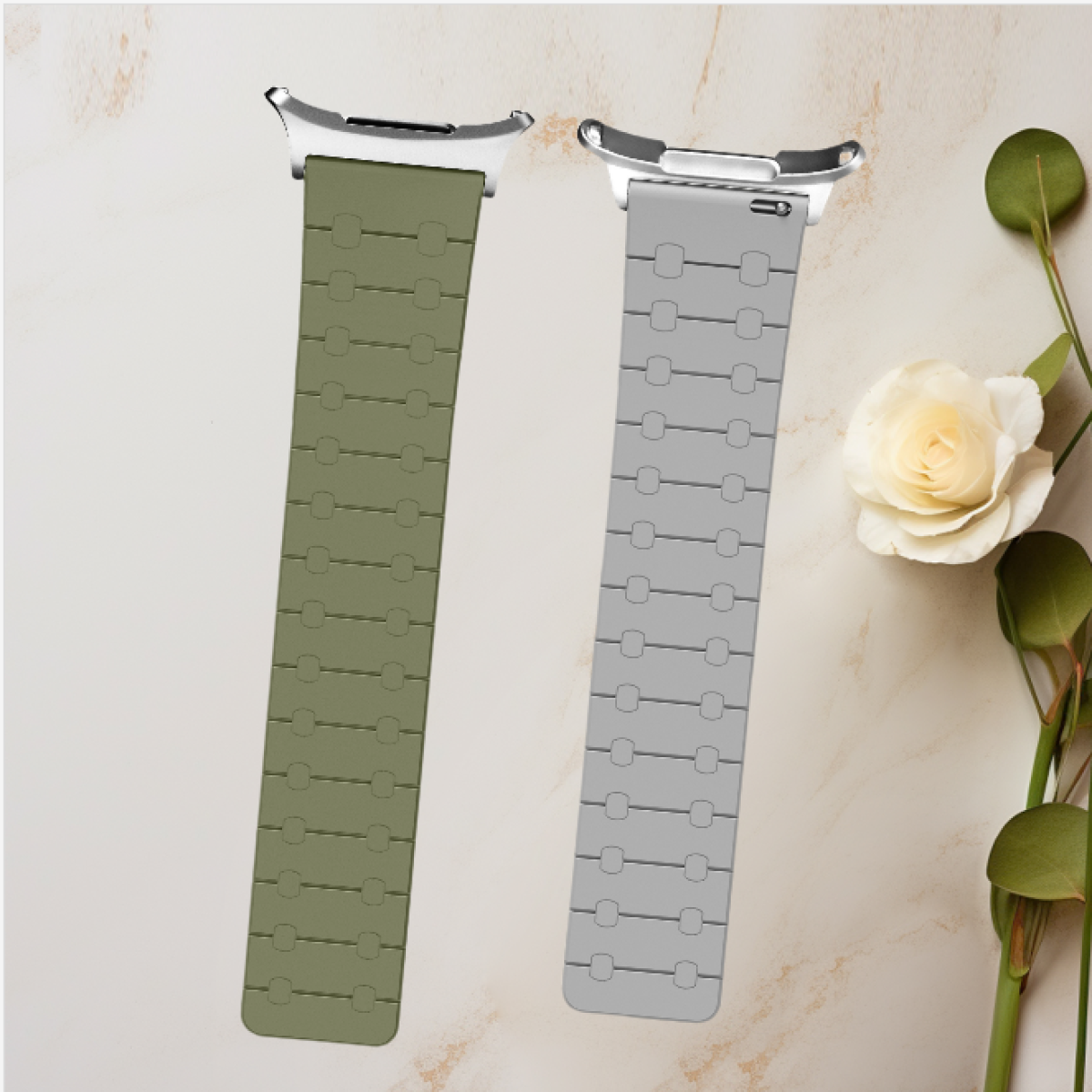 Due cinturini per smartwatch in diversi colori: verde oliva e grigio, con un fiore bianco e foglie verdi.