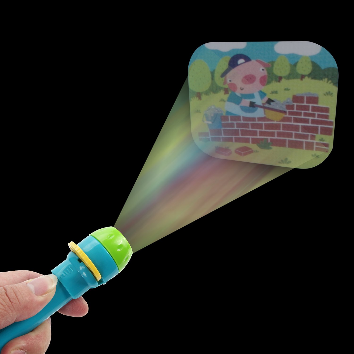 Ein Projektionsspielzeug, das ein Schwein beim Bau einer Ziegelmauer auf schwarzem Grund zeigt.