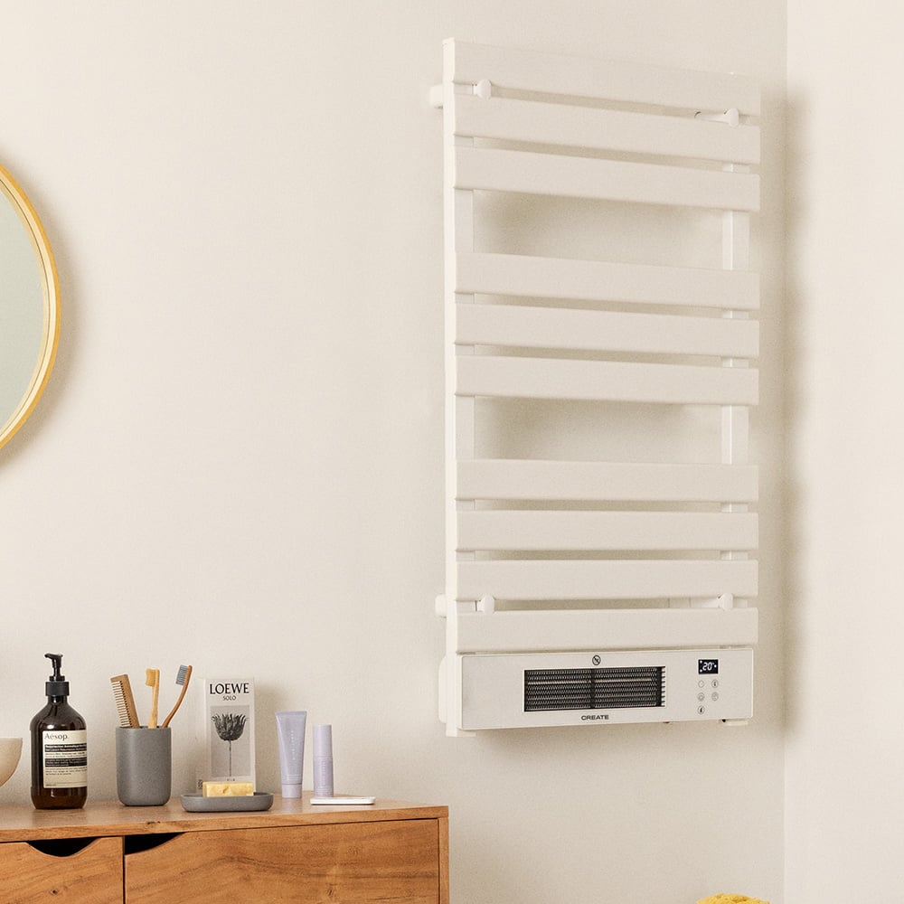 Radiador de baño blanco montado en la pared. Una pared con espejo y otros elementos.