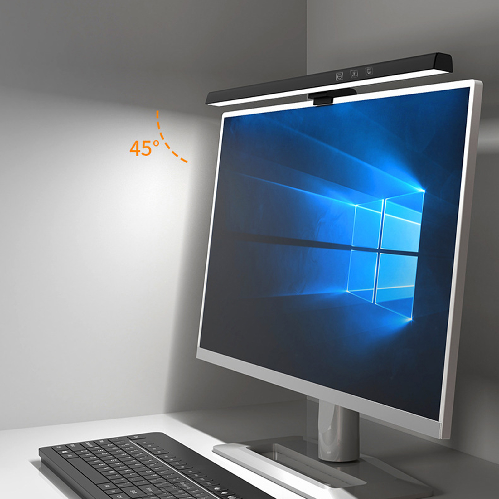 Eine schwarze Monitor-Lichtleiste über einem Computermonitor und einer Tastatur auf weißer Oberfläche.