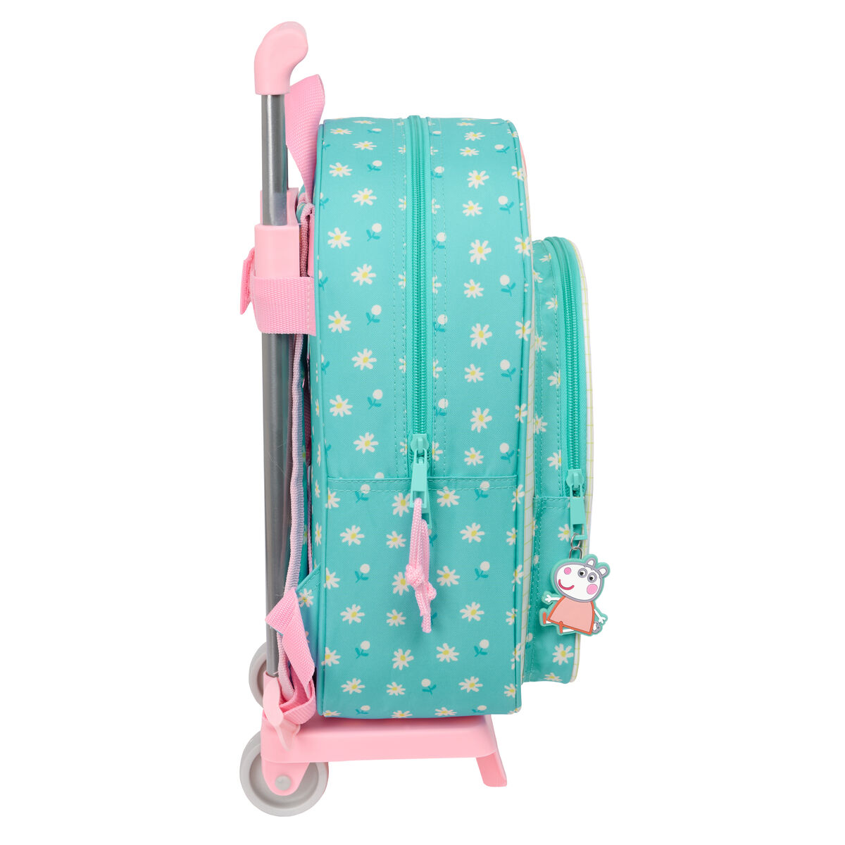 Ein türkisfarbener Rucksack mit Gänseblümchenmustern, Seitenansicht, auf einem rosa Rollwagen. Rosa Griff und Reißverschlüsse.