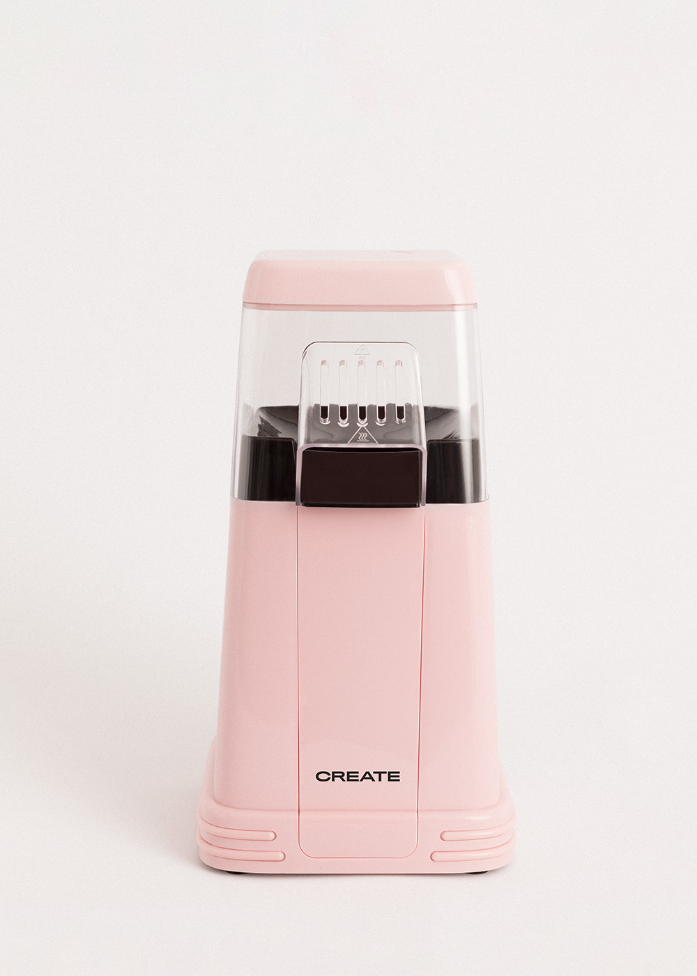 Una máquina de palomitas rosa con 'CREATE' en el frente, sobre un fondo blanco.