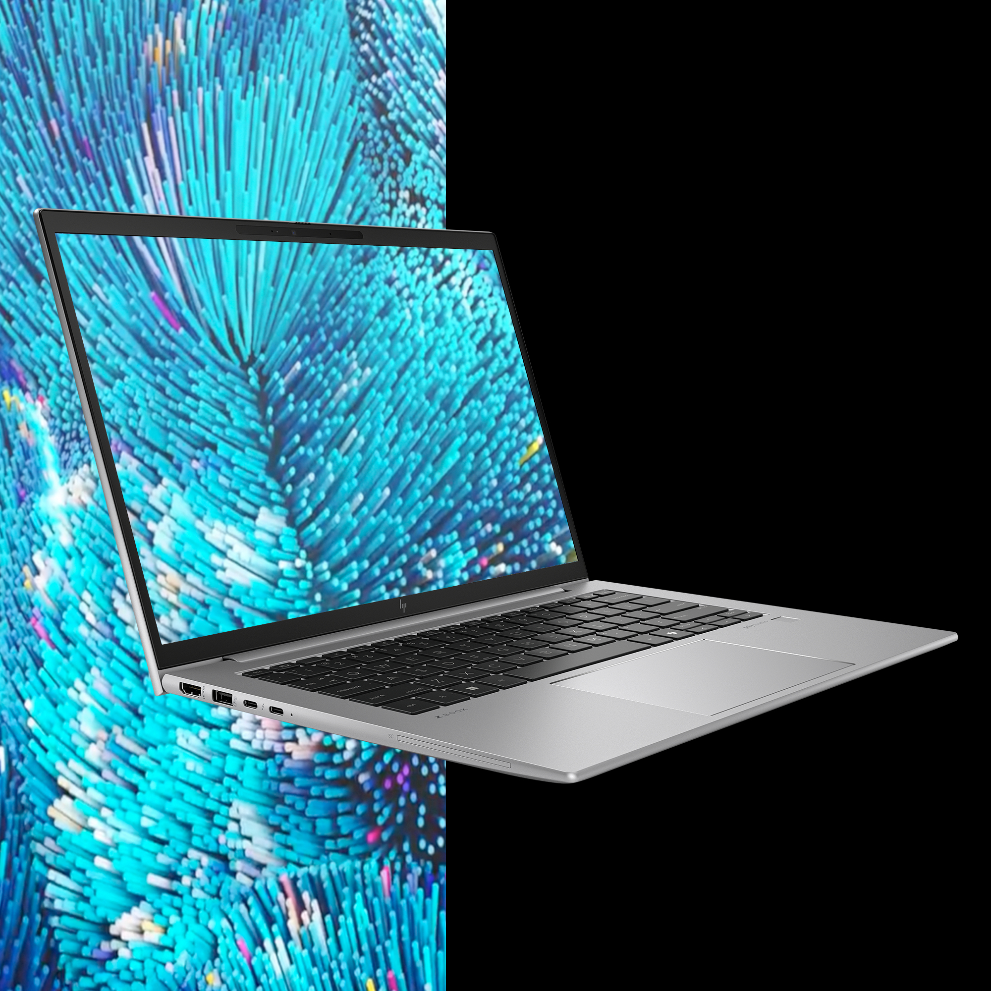 Srebrny laptop na czarnym tle. Otwarty ekran pokazuje niebieski abstrakcyjny wzór.