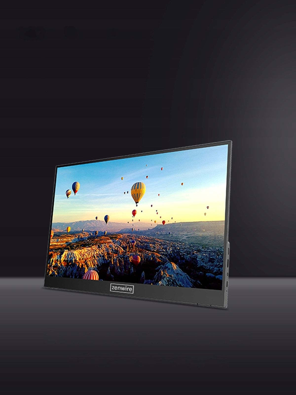 Czarny monitor wyświetlający malowniczy widok z balonami na tle ciemnego tła.