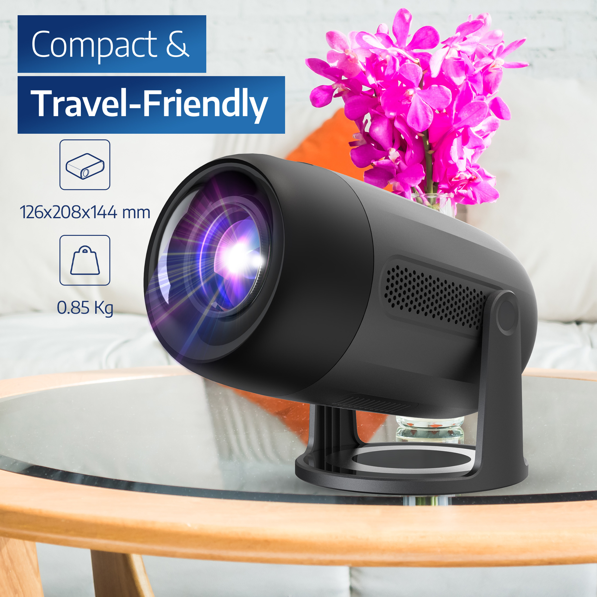 Black projector with dimensions. It sits on a table with a vase of pink flowers.
