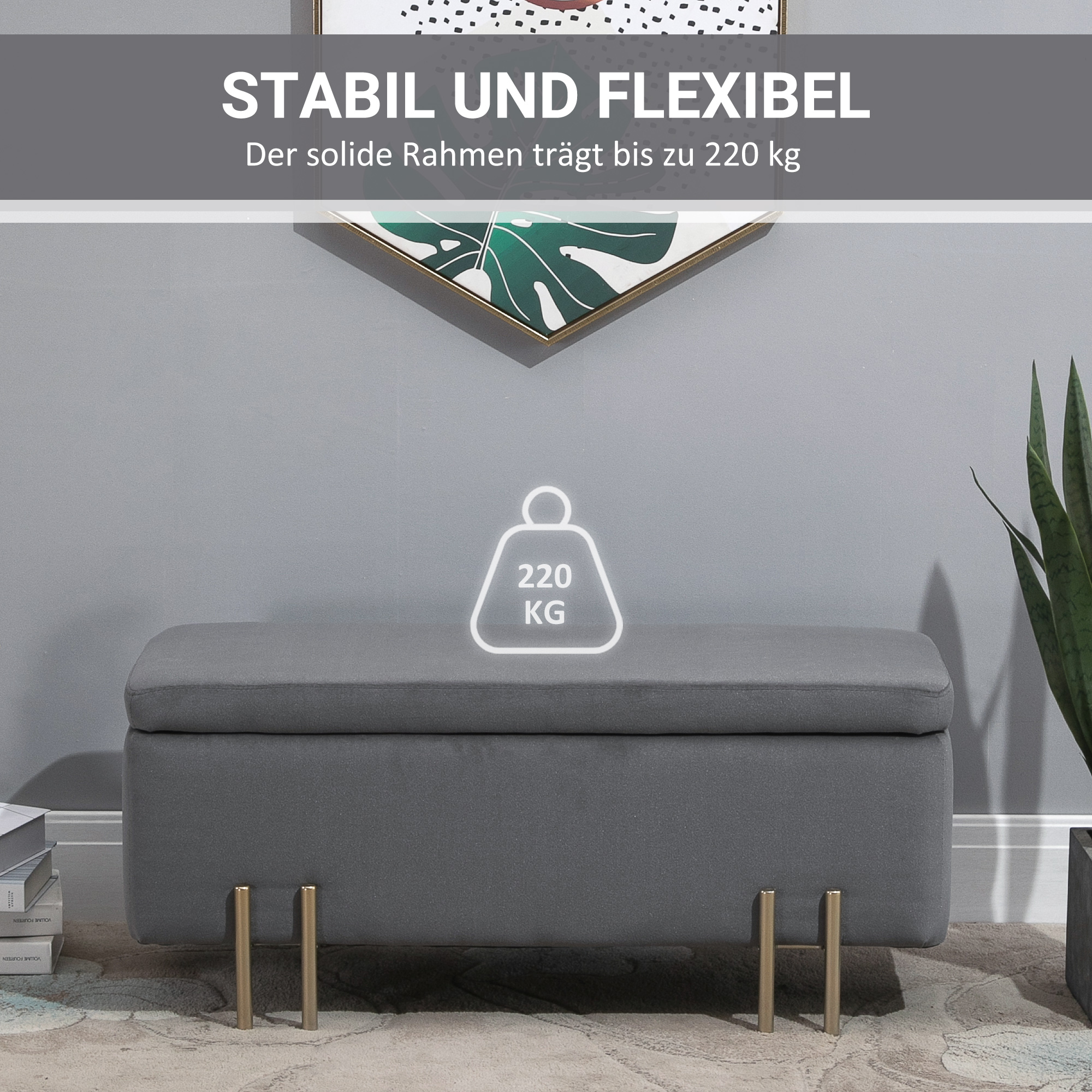 Graue Stauraumbank mit goldenen Beinen, unter einem weißen dekorativen Kunstwerk.