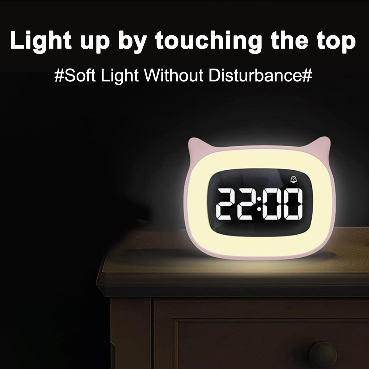 Rosa katzenförmige Nachttischuhr mit leuchtendem Display. Text: Light up by touching the top.