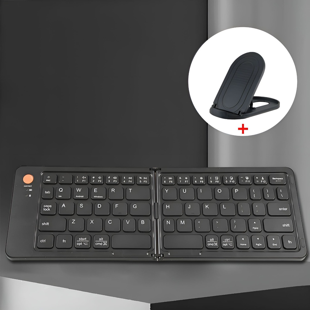 Faltbare, schwarze Tastatur mit rotem Einschaltknopf. Ein Telefonständer ist ebenfalls im Bild vorhanden.