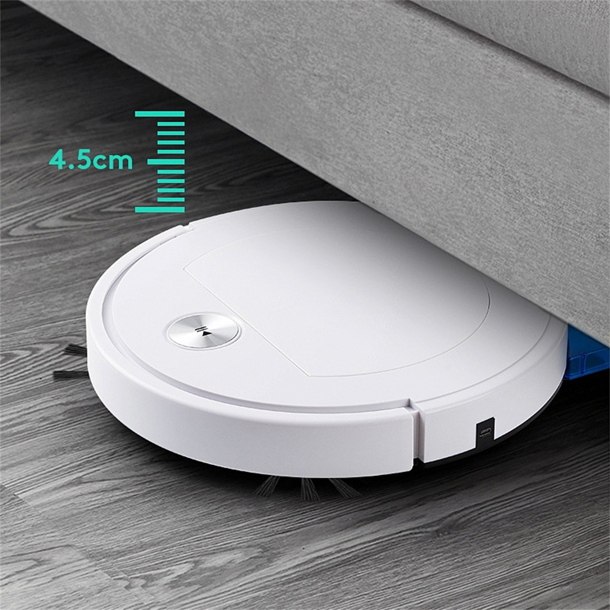 Weißer Roboter-Staubsauger unter einem grauen Sofa. Er ist nah am Boden.