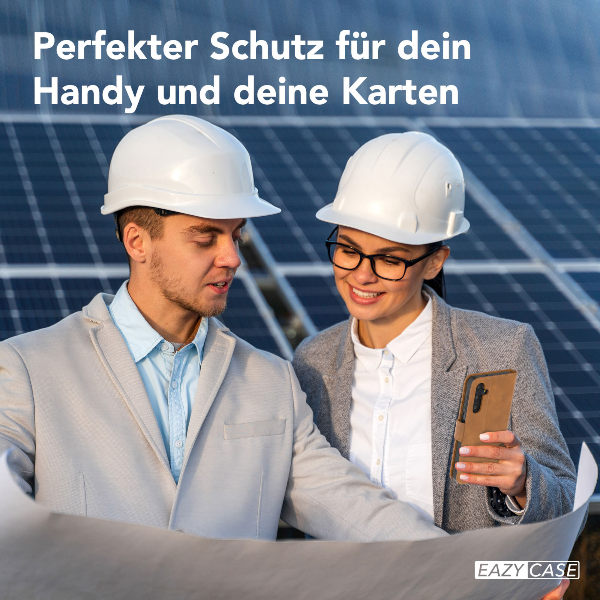 Zwei Personen mit Schutzhelmen betrachten einen Bauplan, mit einer Handyhülle.