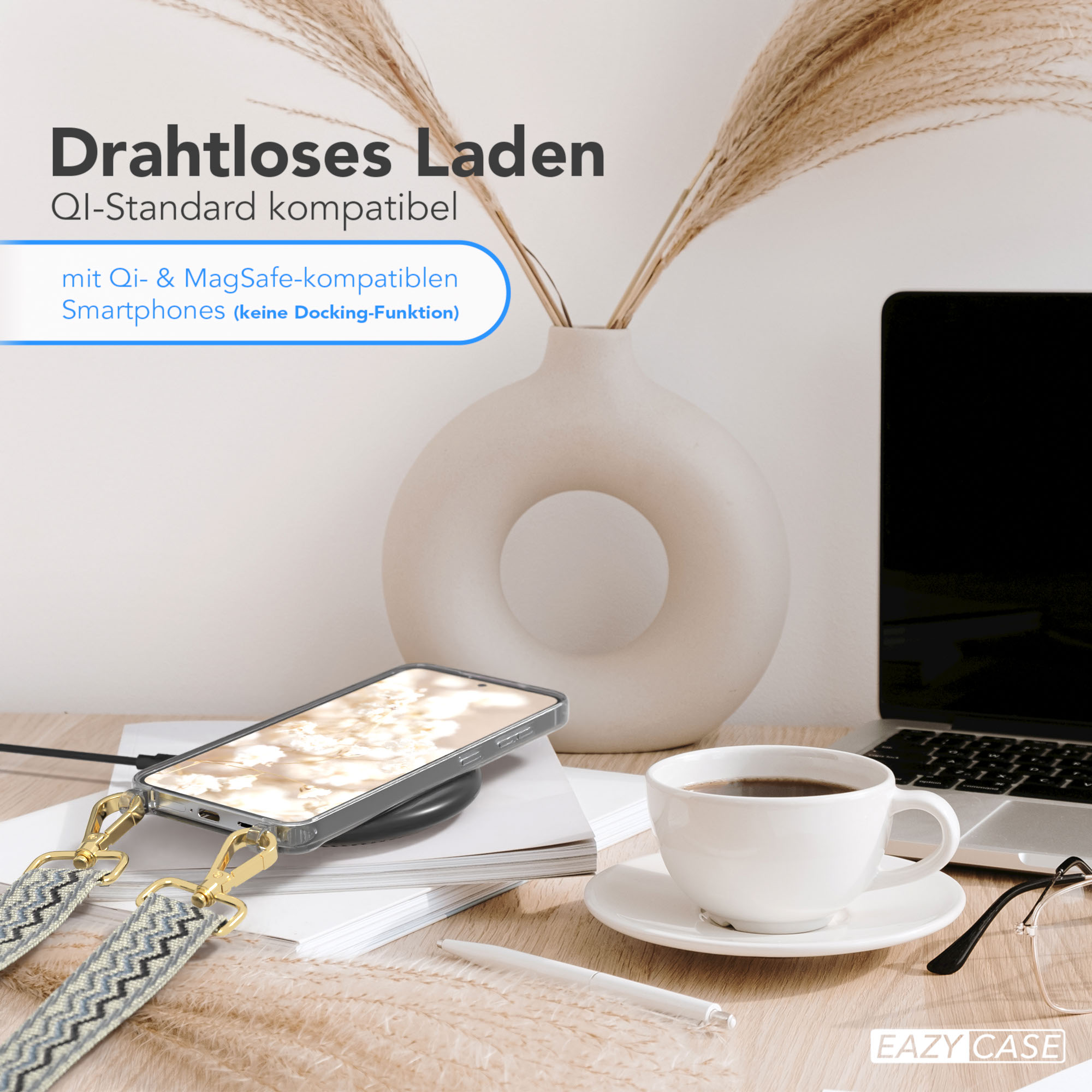 Ein Telefon, das drahtlos auf einem Pad geladen wird, mit einer Kaffeetasse, Brille und einem Stift auf einem Schreibtisch.