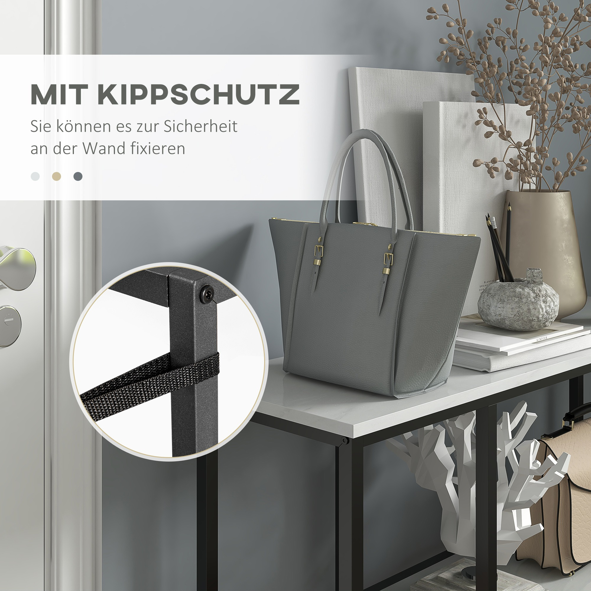 Eine graue Tasche auf einem weißen Tisch mit anderen Gegenständen. Text: MIT KIPPSCHUTZ, Sie können es zur Sicherheit an der Wand fixieren.