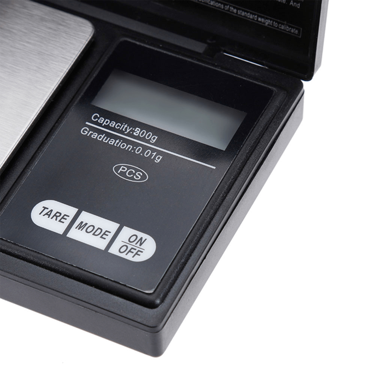 Schwarze digitale Taschenwaage mit LCD-Anzeige. Zeigt Kapazität, Teilung und TARE-, MODE- und ON/OFF-Tasten.