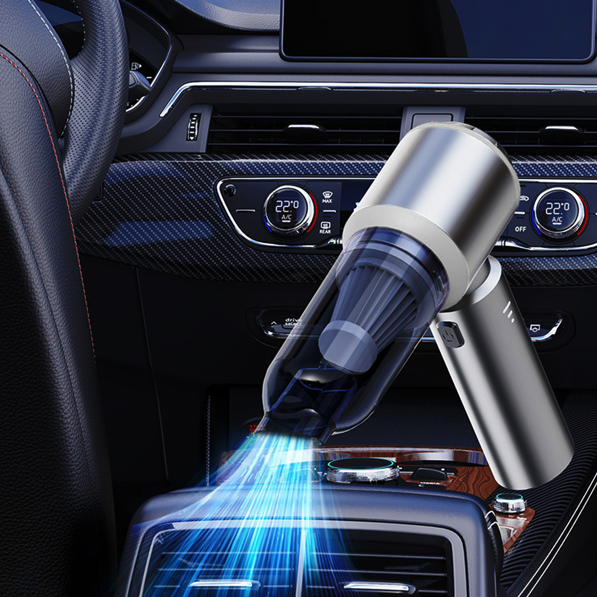 Ein Handstaubsauger wird in einem Auto verwendet. Blaues Licht zeigt die Saugwirkung.