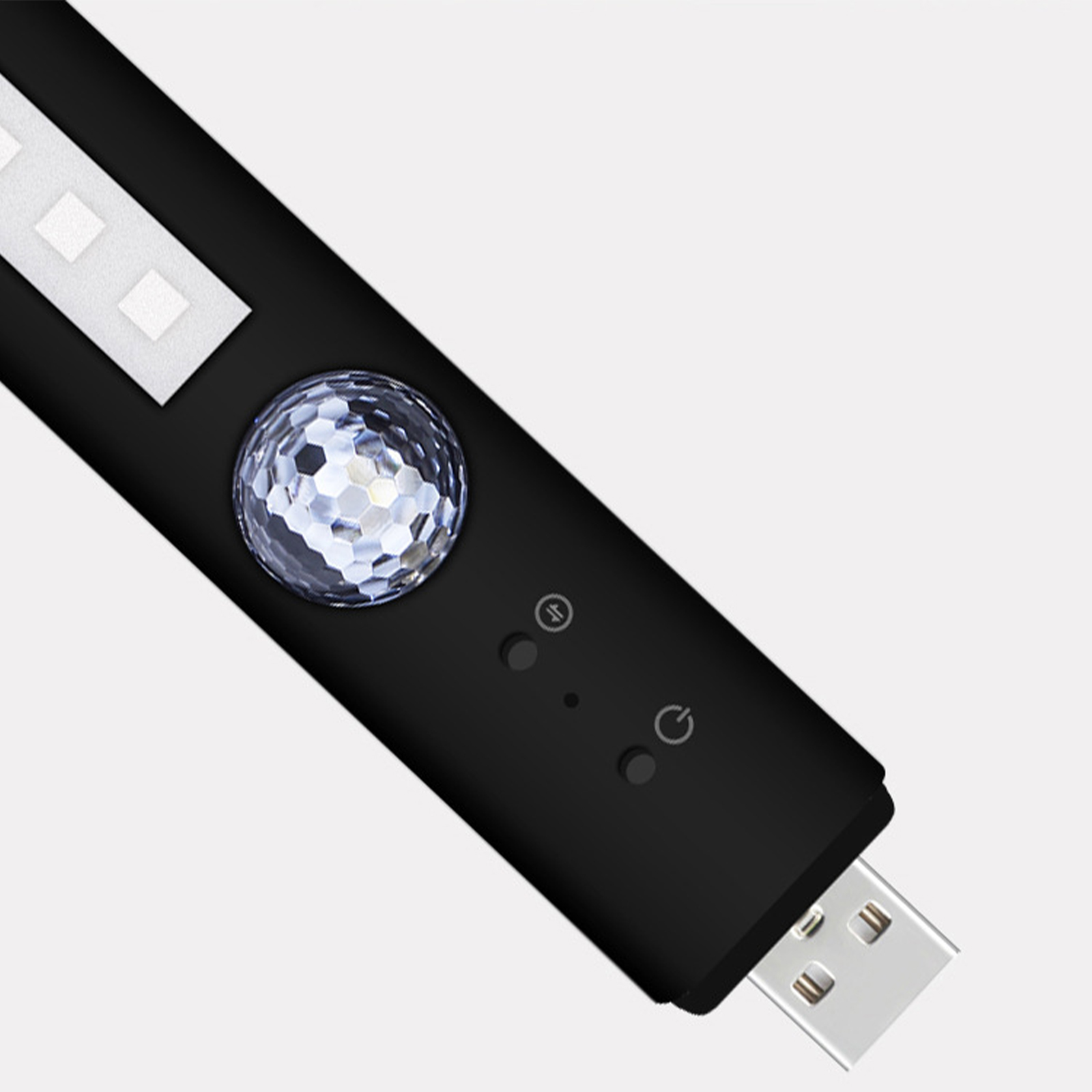 Ein schwarzes USB-Gerät mit einem kristallartigen Knopf und zwei Kontrollleuchten.