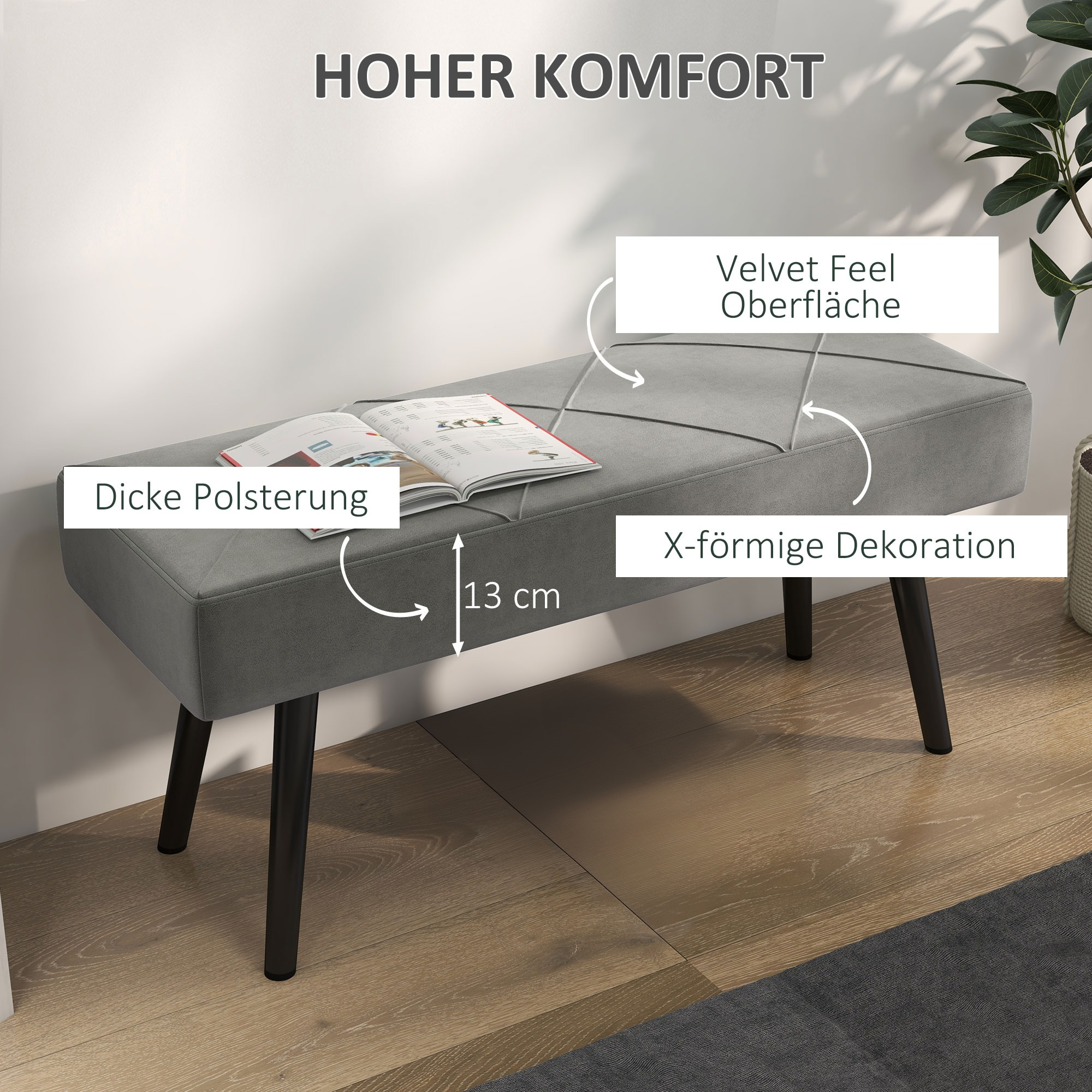Graue Bank mit dicker Polsterung, X-förmiger Dekoration und schwarzen Beinen. Text kennzeichnet 'Hoher Komfort'.