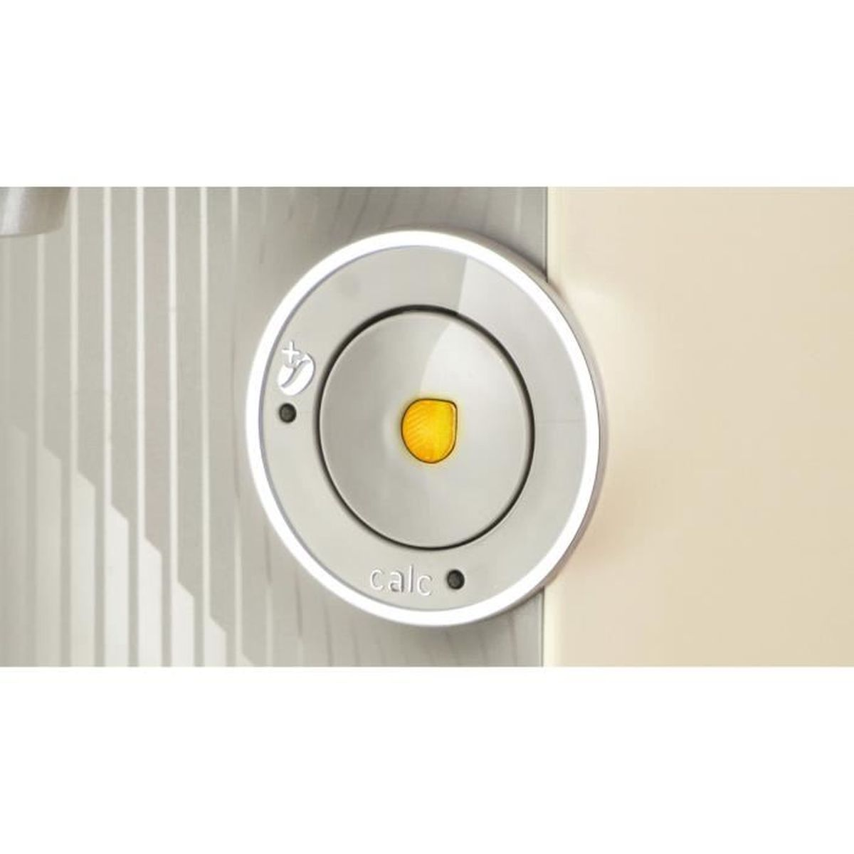 Okrągły biało-szary czujnik drzwi z żółtym środkiem.