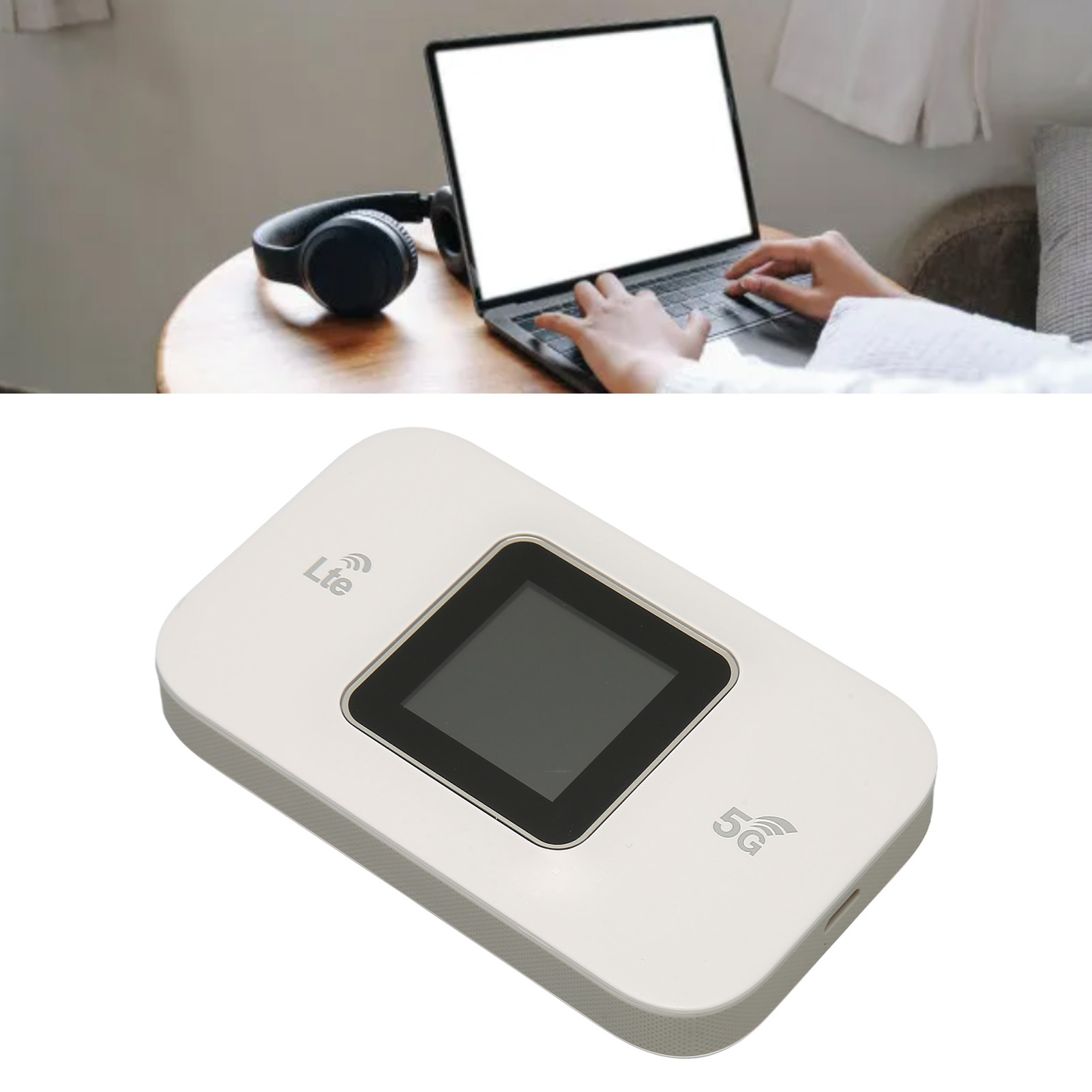 Ein Laptop und ein mobiler WLAN-Router auf einem Tisch. Eine Person tippt auf dem Laptop.