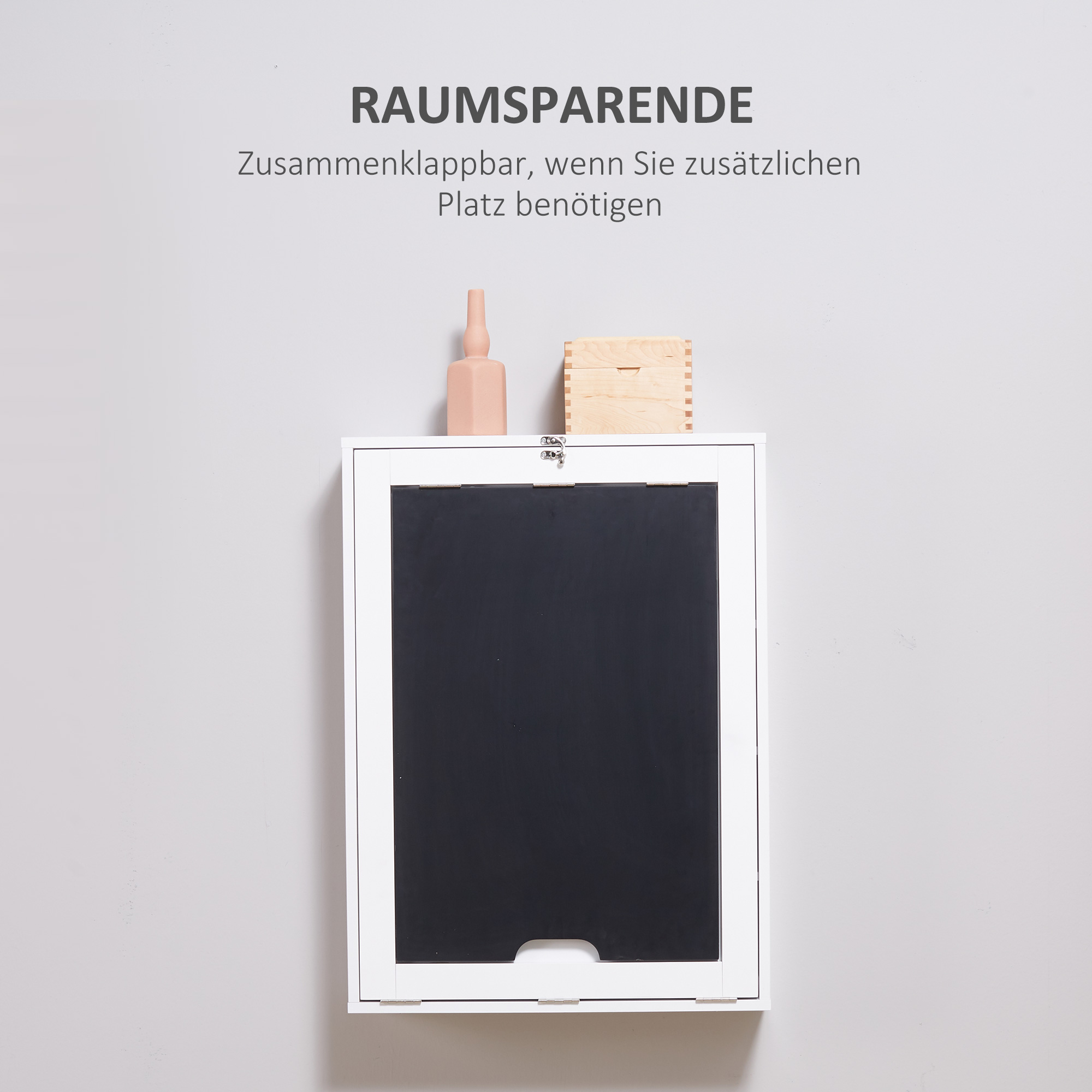 Ein weißer, an der Wand montierter Schrank mit schwarzer Falttür.
